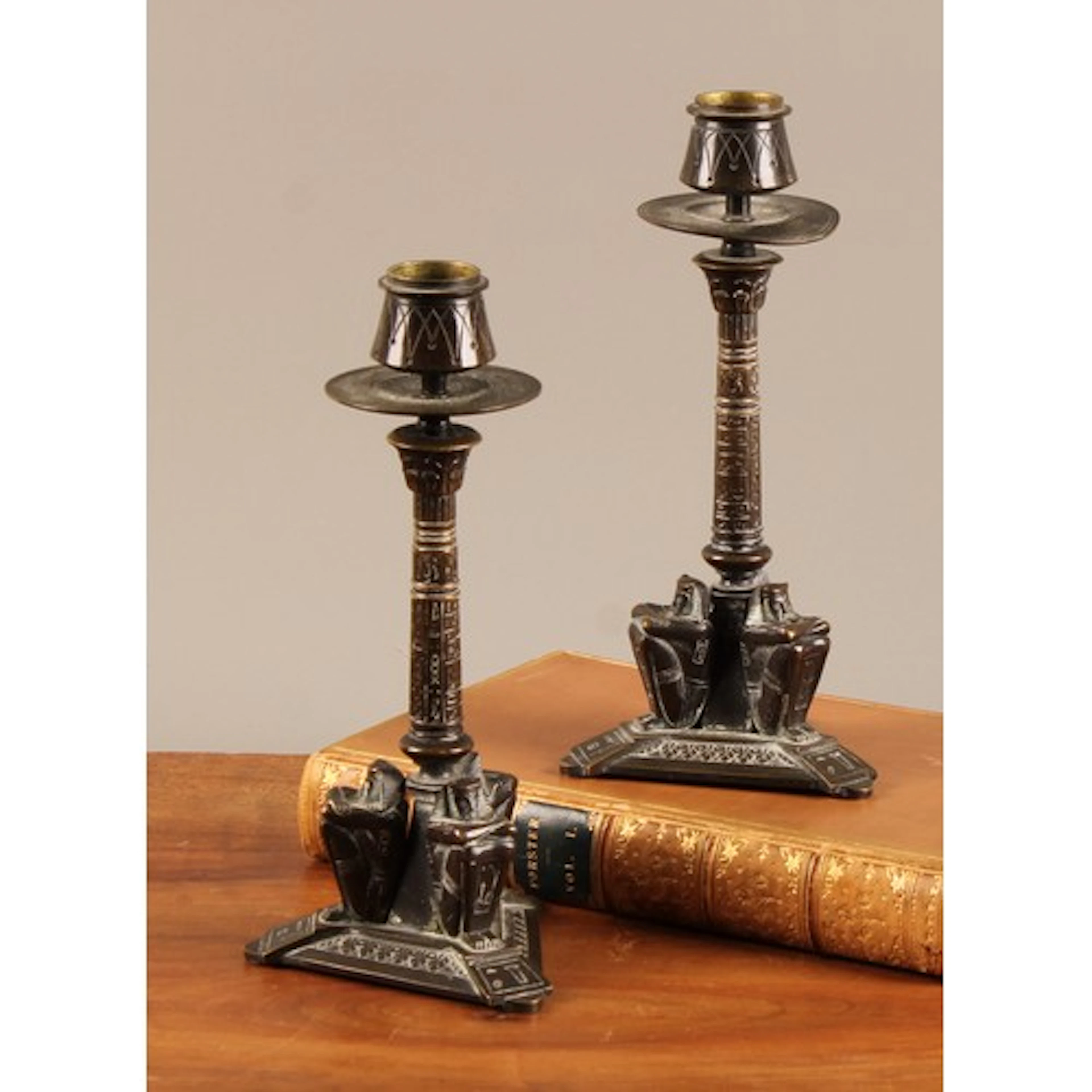A pair of 19th century Egyptian Revival bronze candlesticks,...