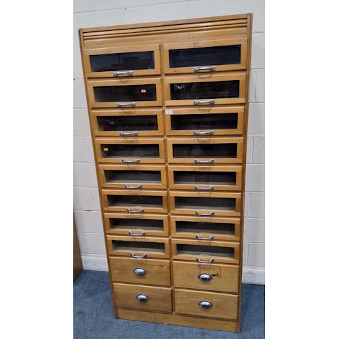 AN EARLY 20TH CENTURY OAK HABERDASHERY CABINET, fitted with ...