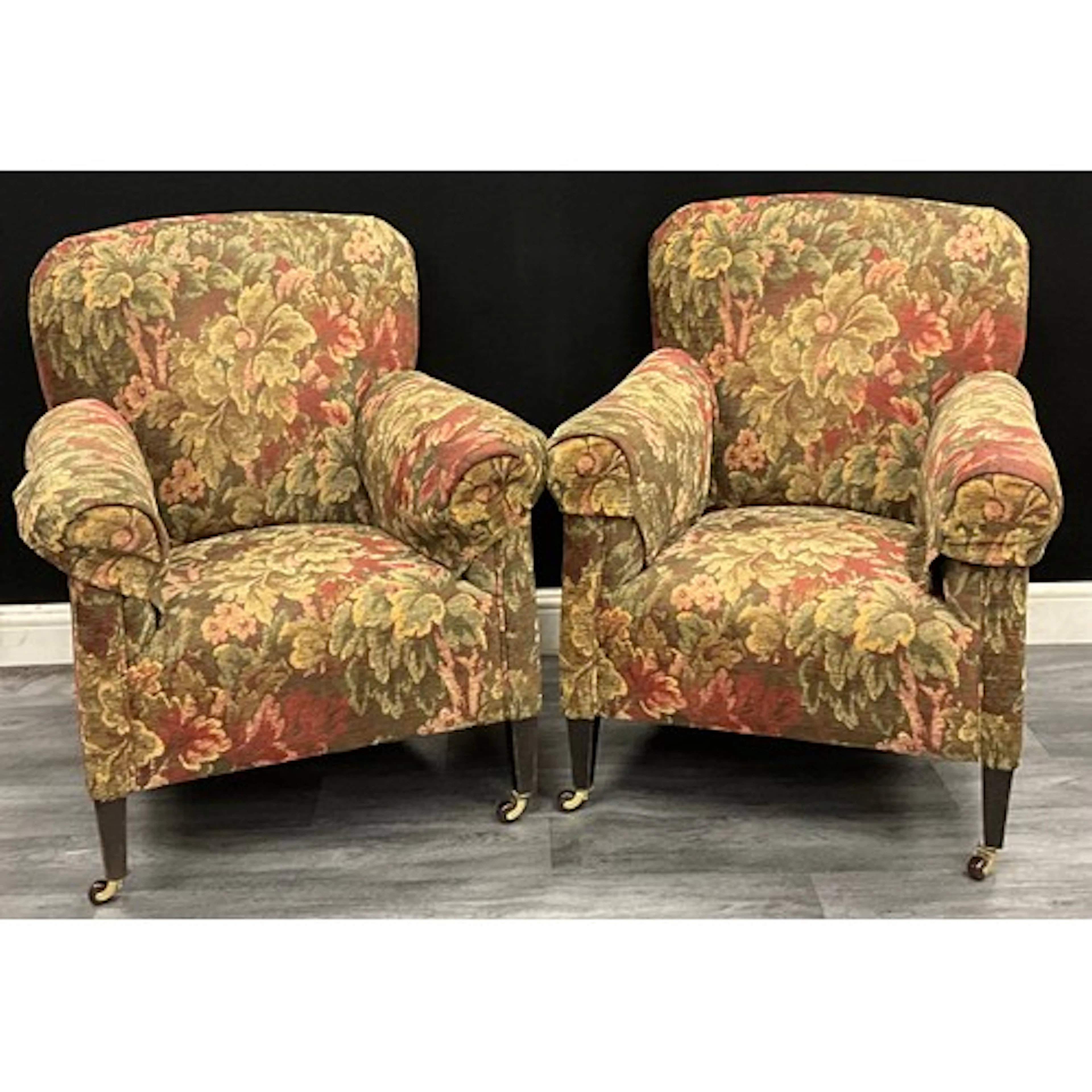 A pair of Edwardian club armchairs, floral damask upholstery...