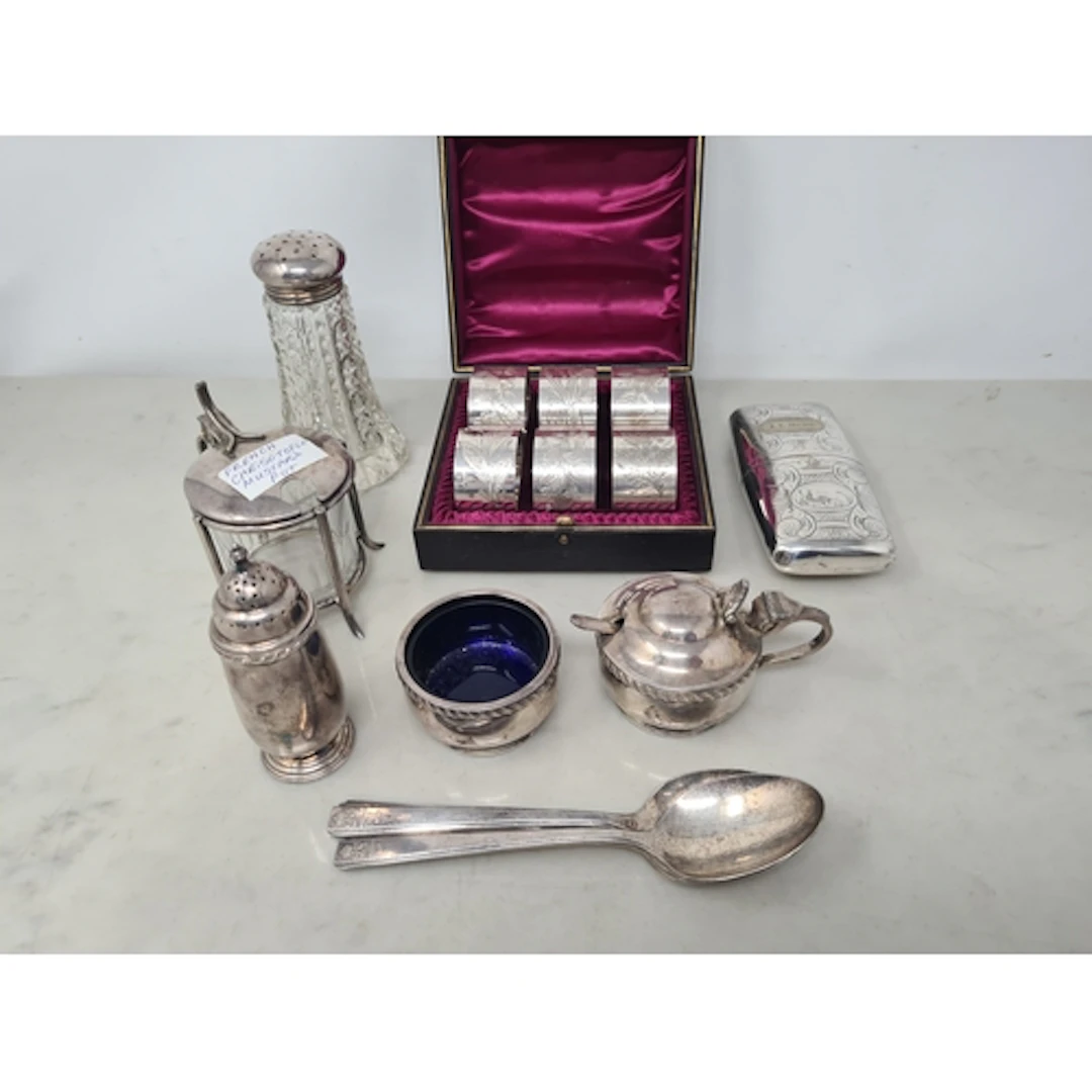 Six plated Napkin Rings with floral engraving, in case, a Ci...