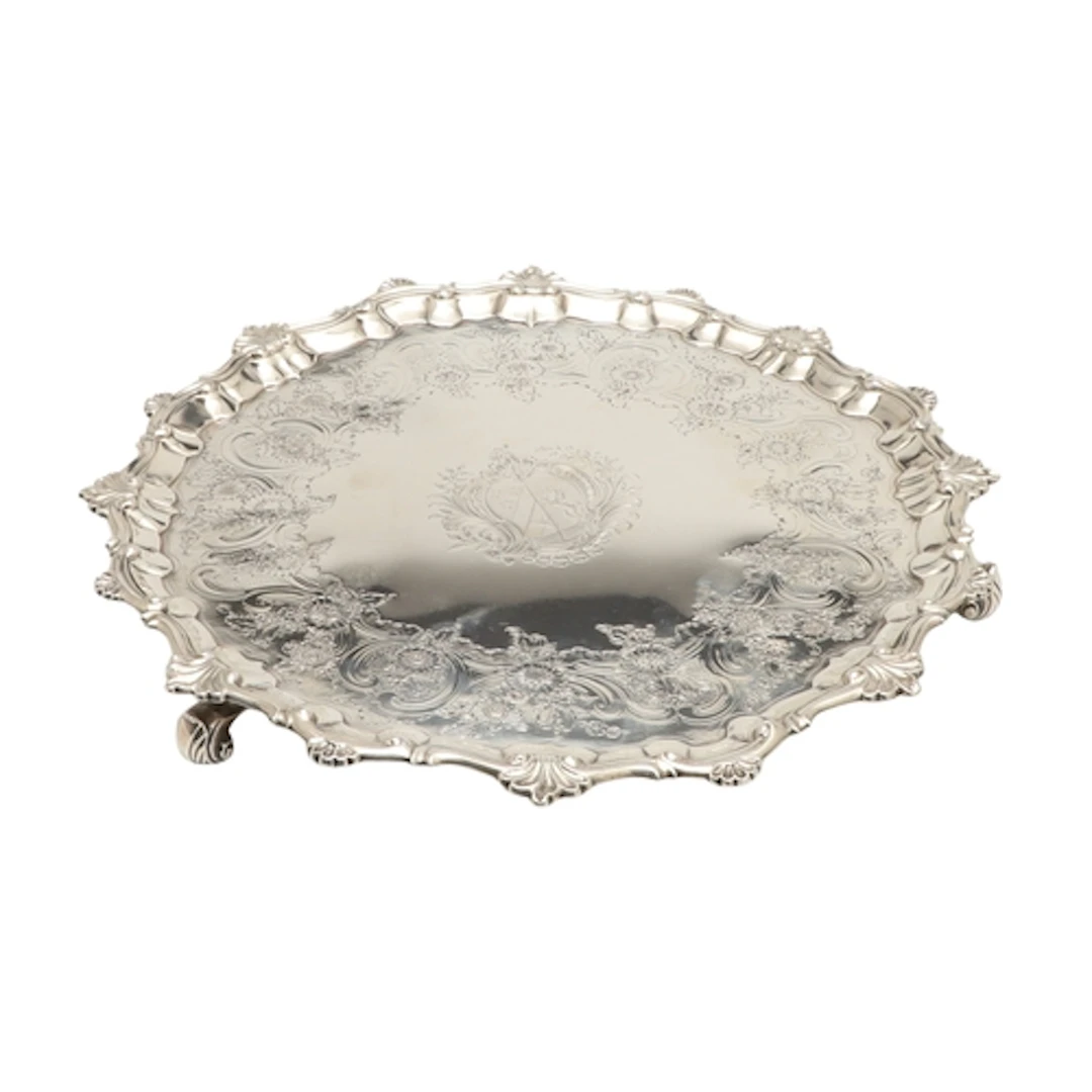 A GEORGE II SILVER SALVER. With cast shell and scroll border...