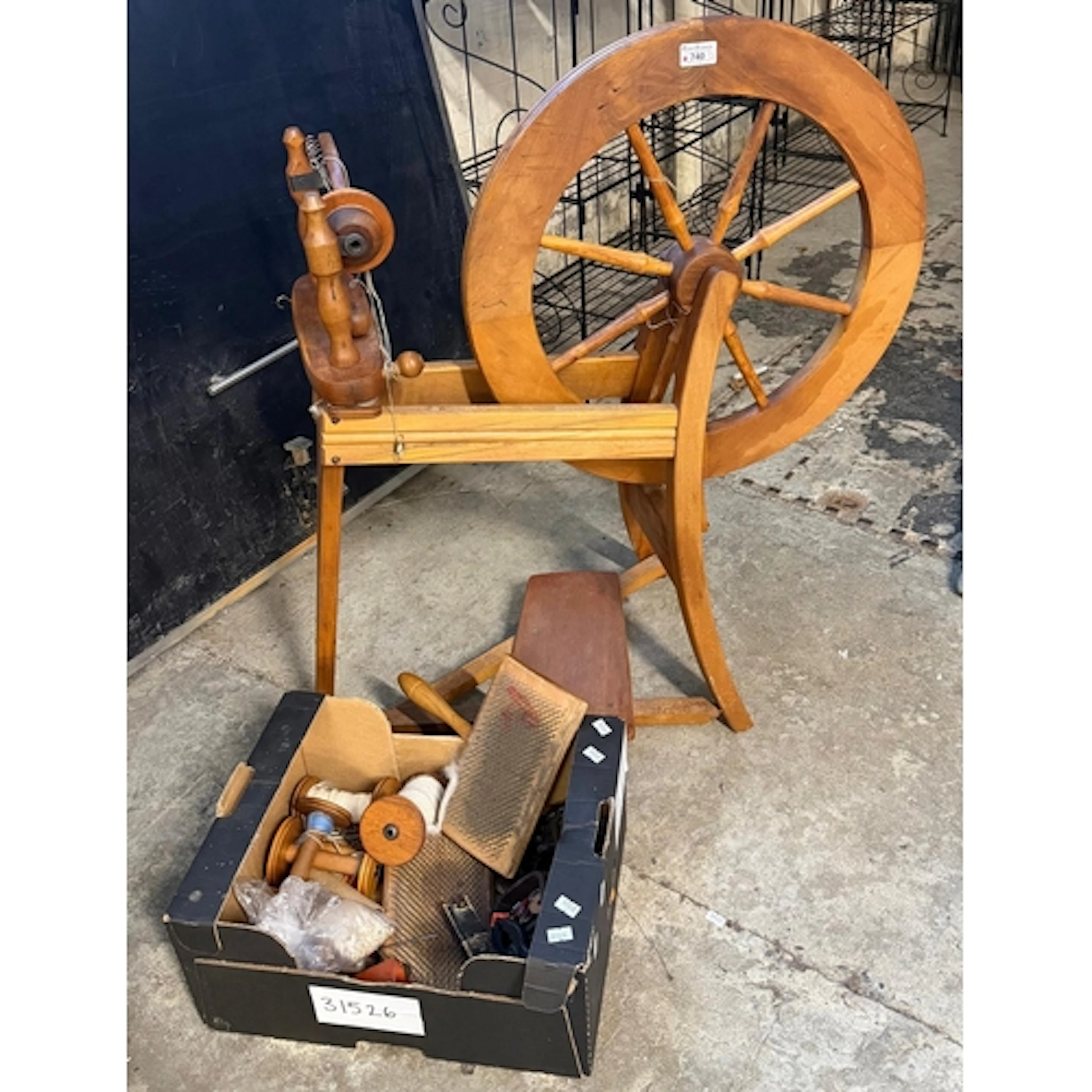 Modern hardwood treadle spinning wheel with various accessor...