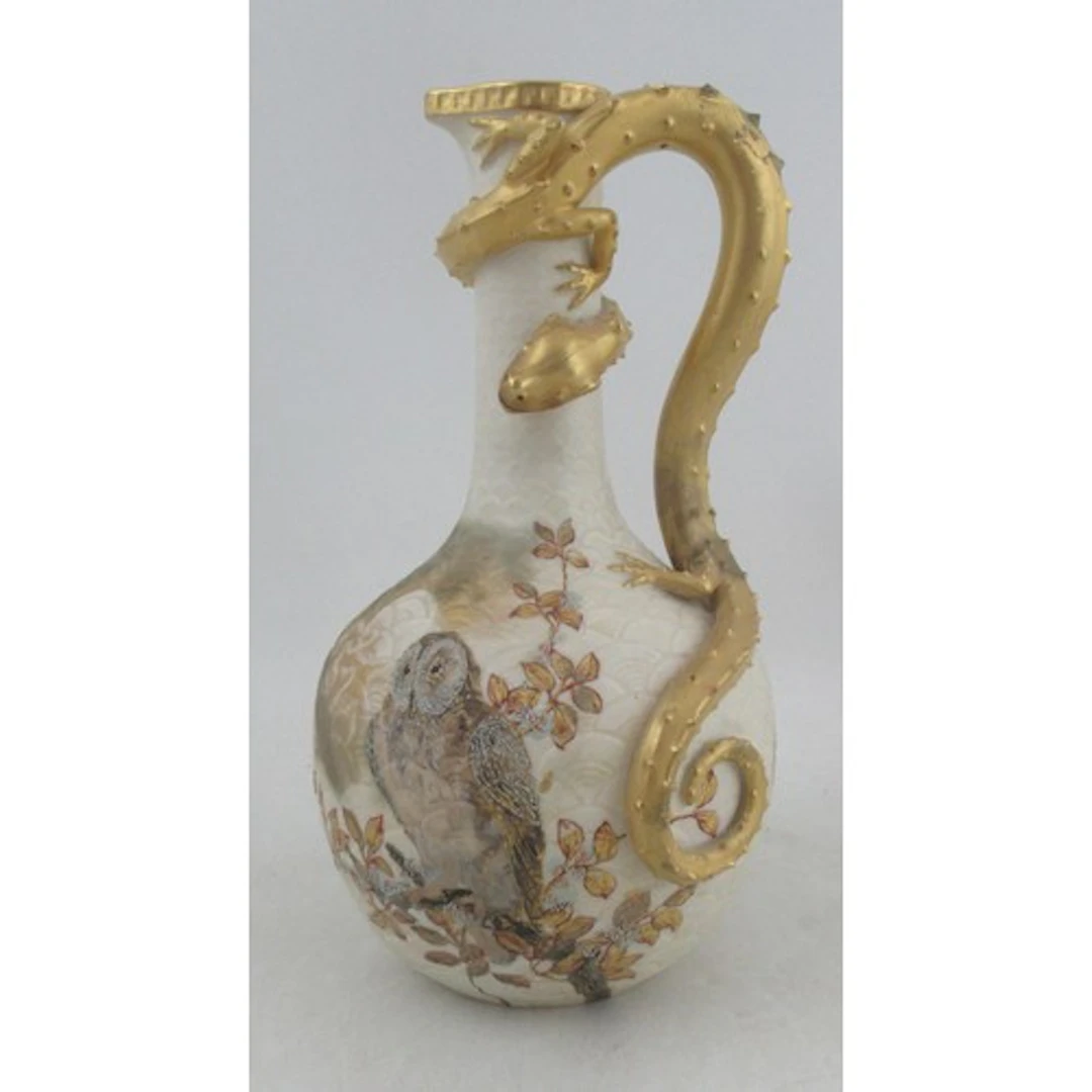 A Royal Worcester gilded ivory ewer, the scale embossed grou...