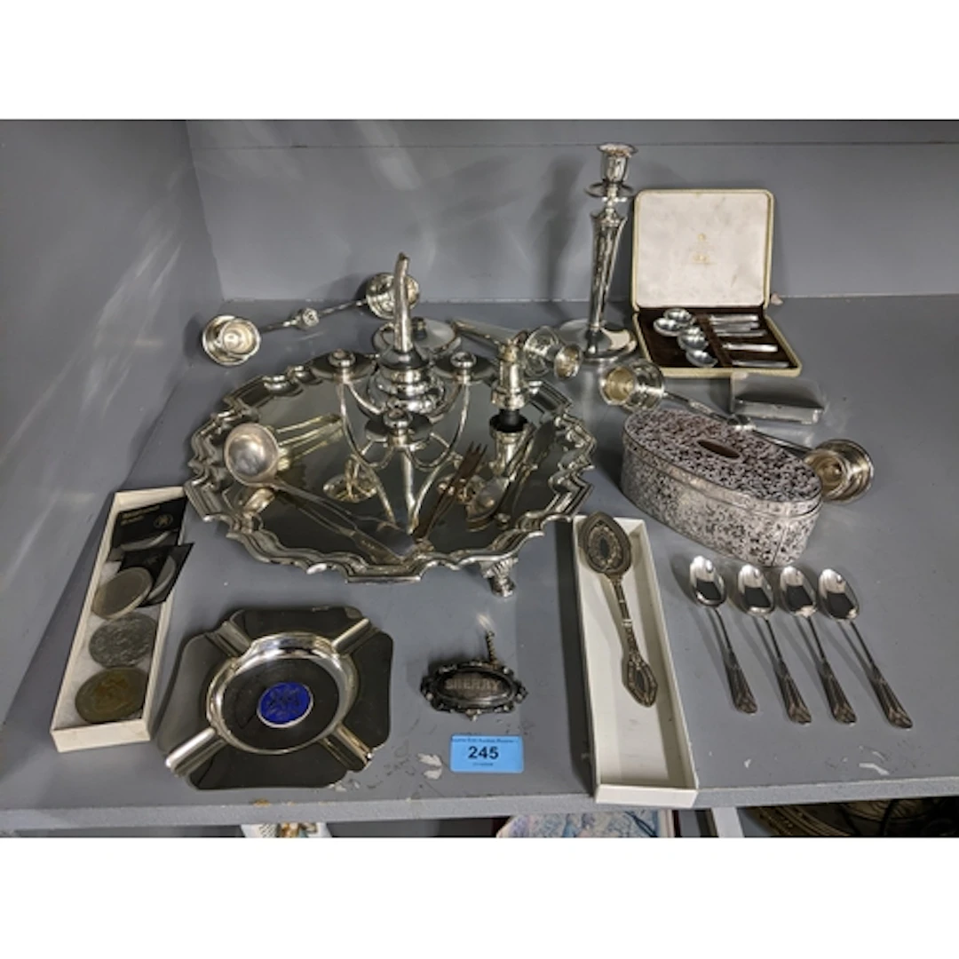 A selection of silver plate to include a circular tray, wine...