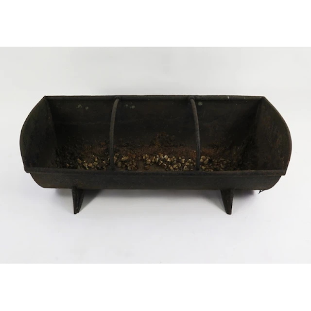 A three division cast iron feeding trough, raised on splayed...
