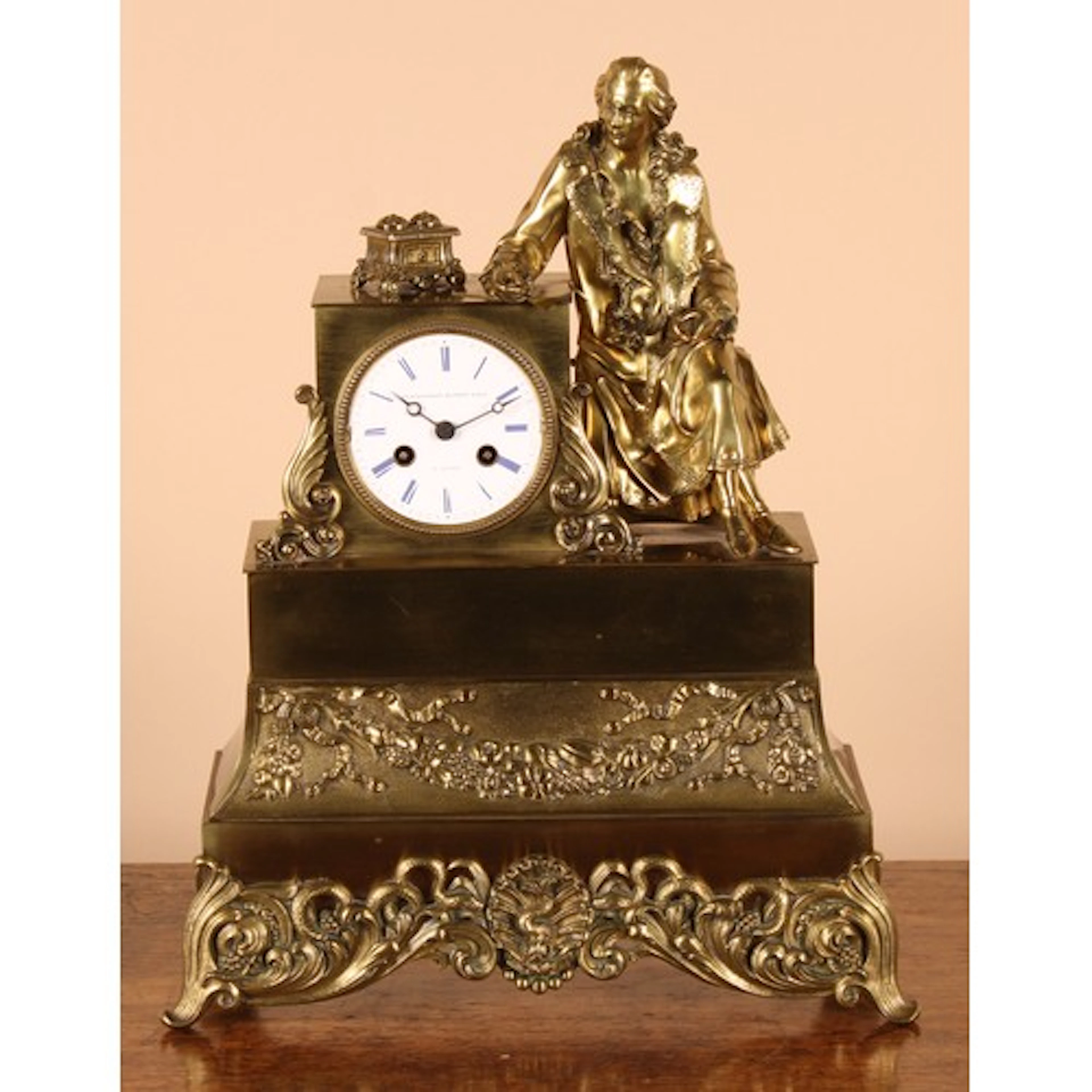A 19th century French brass and ormolu mantel clock, the ena...