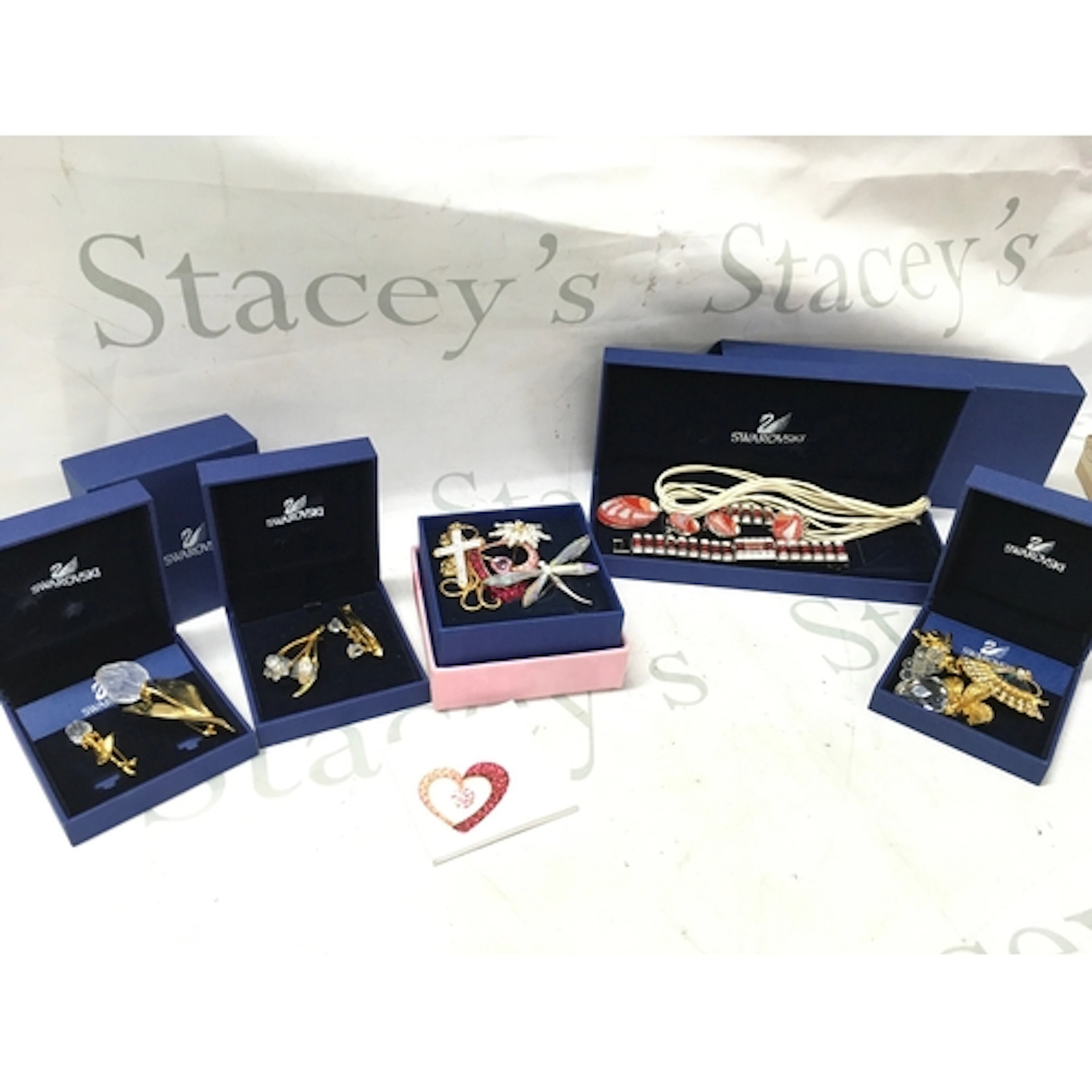 A collection of Swarovski boxed jewellery including brooches...
