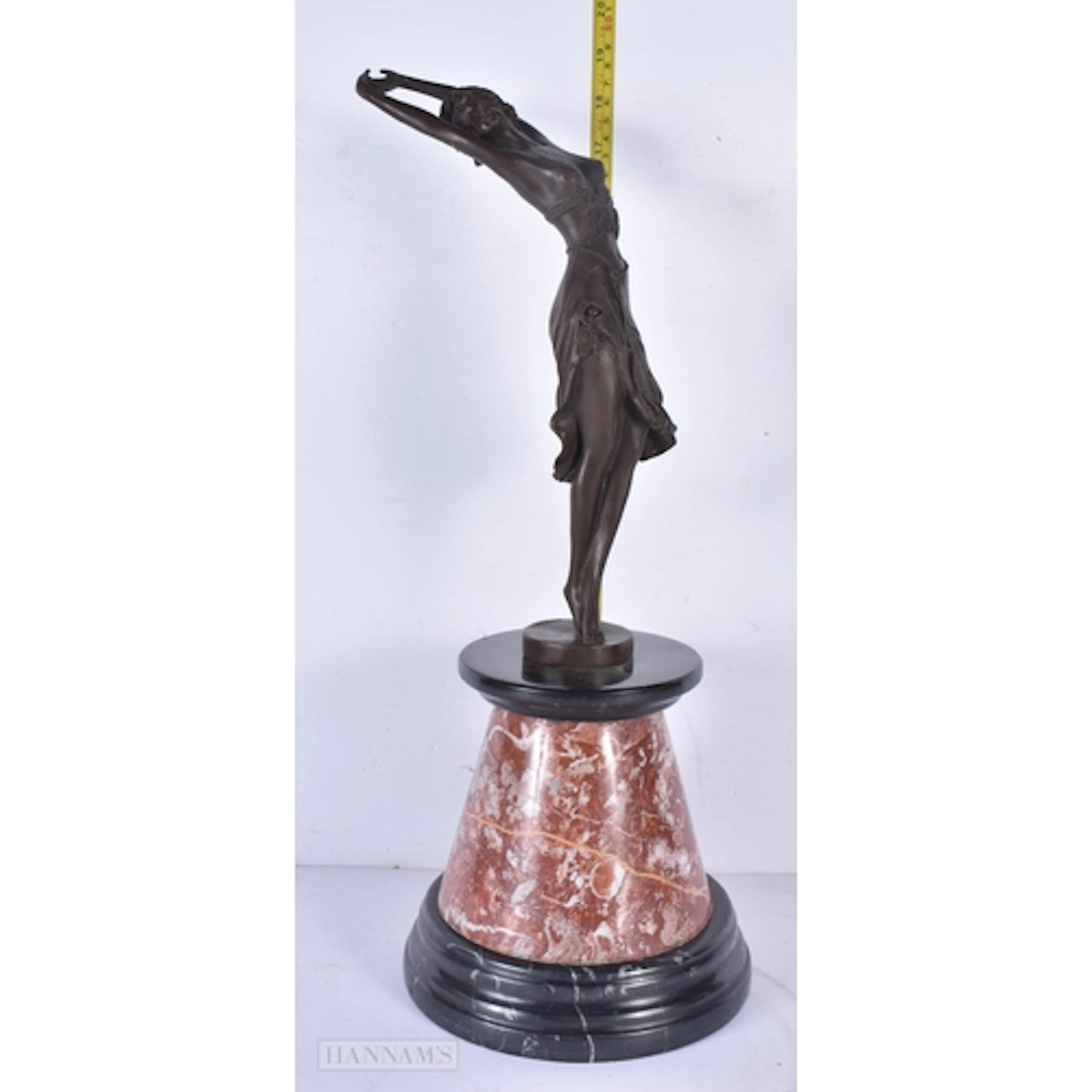 A marble mounted art deco style bronzed dancing figure of a ...