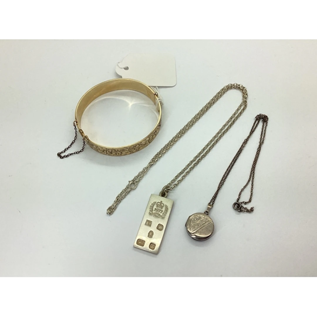 A Hallmarked Silver 1977 Ingot Pendant, together with a circ...