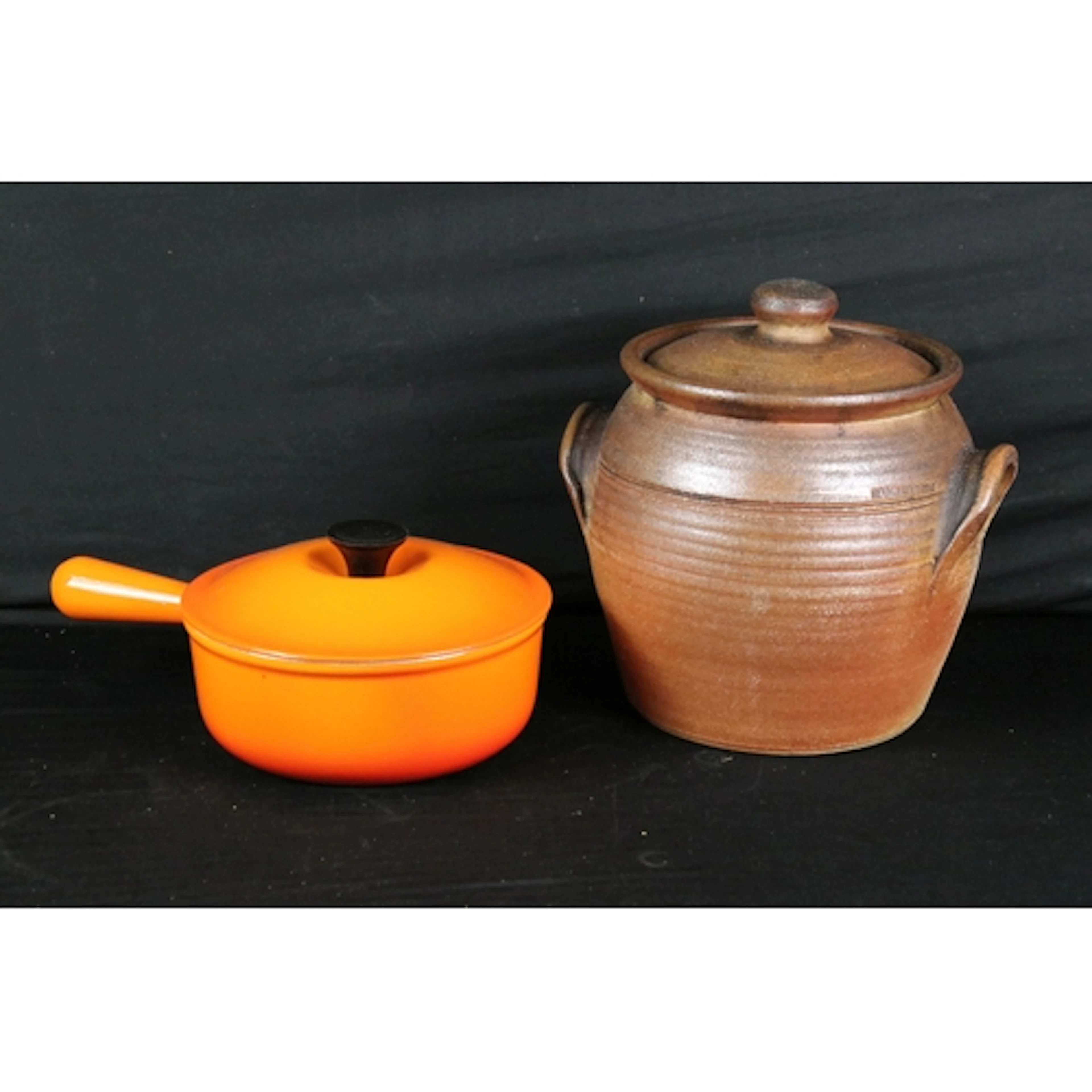 Le Creuset cast iron enamel orange saucepan together with a ...