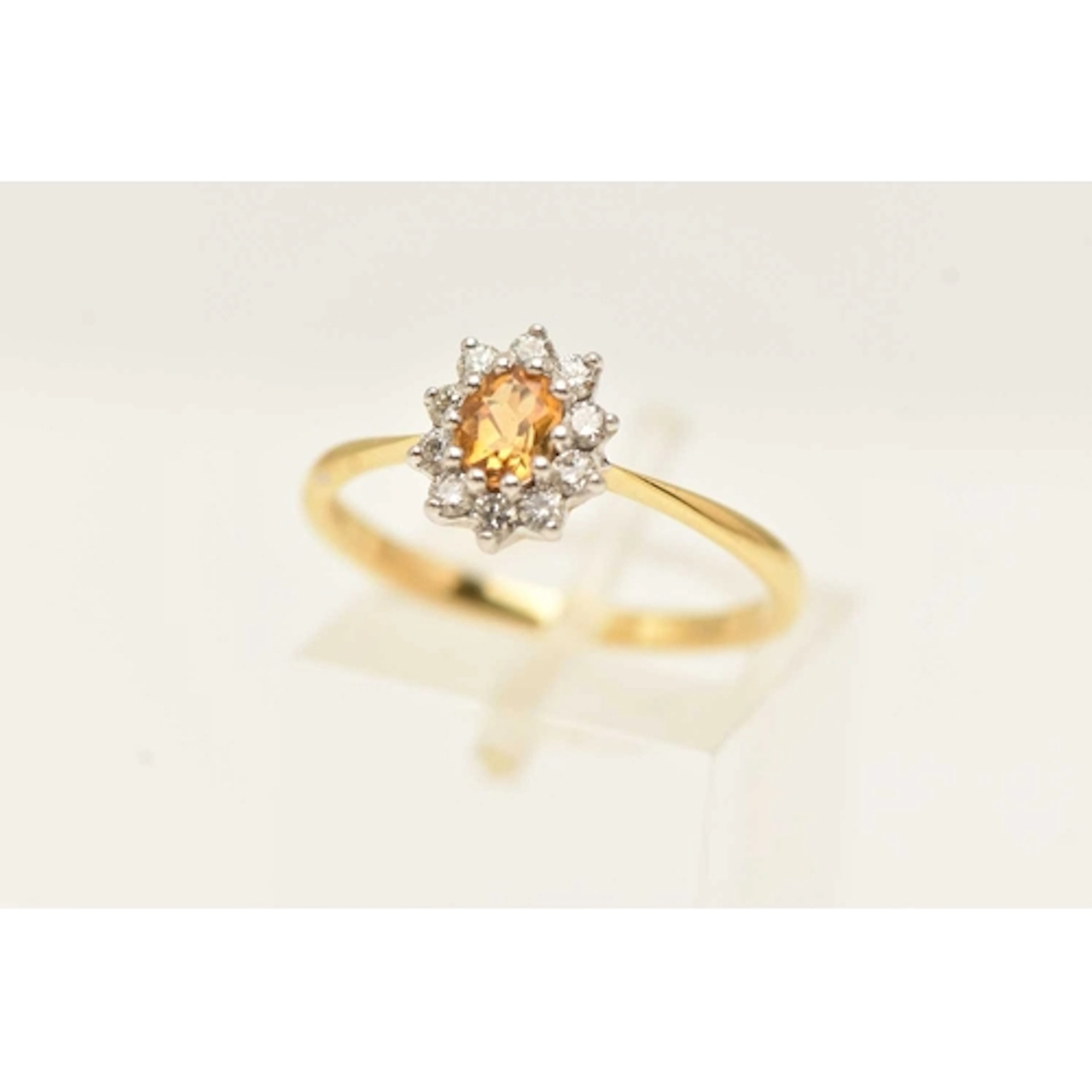 AN 18CT YELLOW GOLD GEM SET CLUSTER RING, an oval cut citrin...