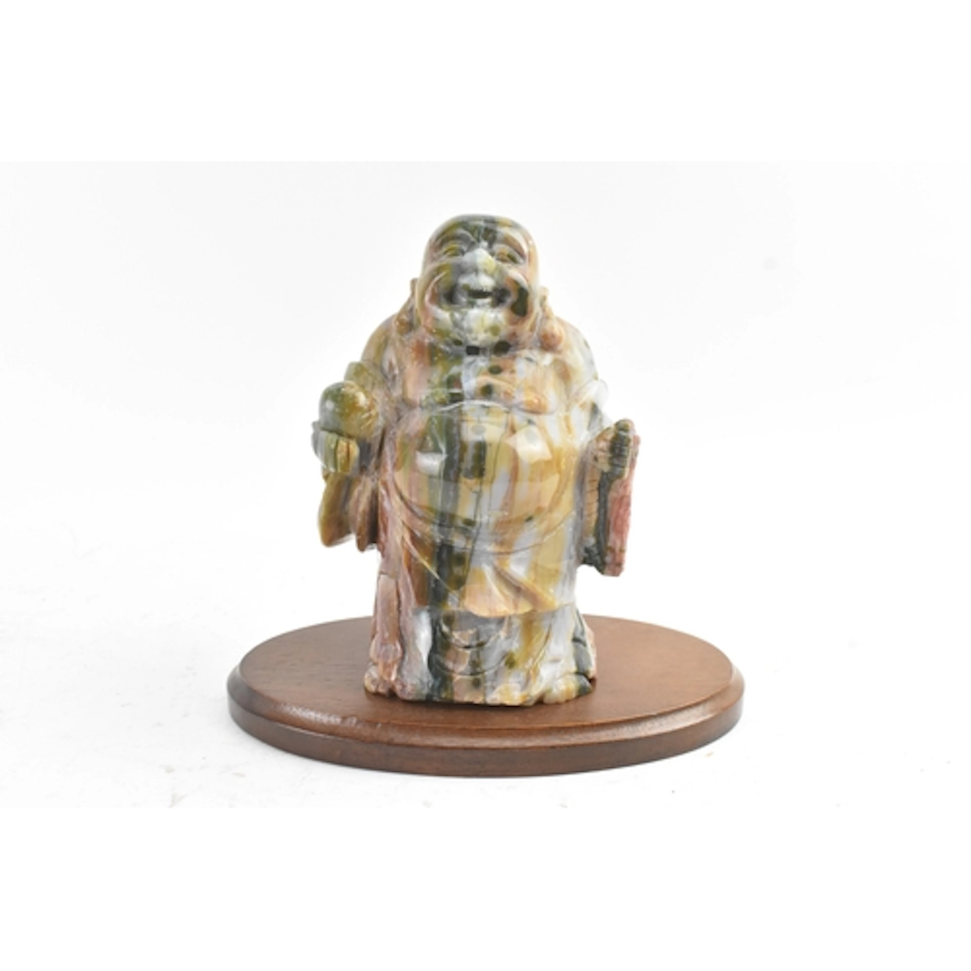 A carved ocean jasper figure of Buddha, modelled standing an...