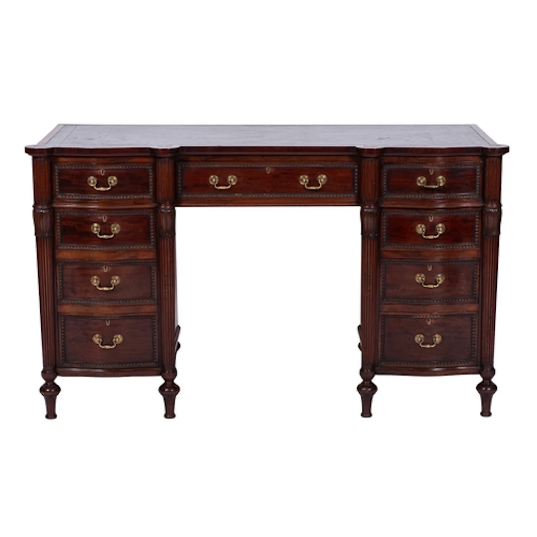 An Edwardian mahogany kneehole desk of shaped and serpentine...