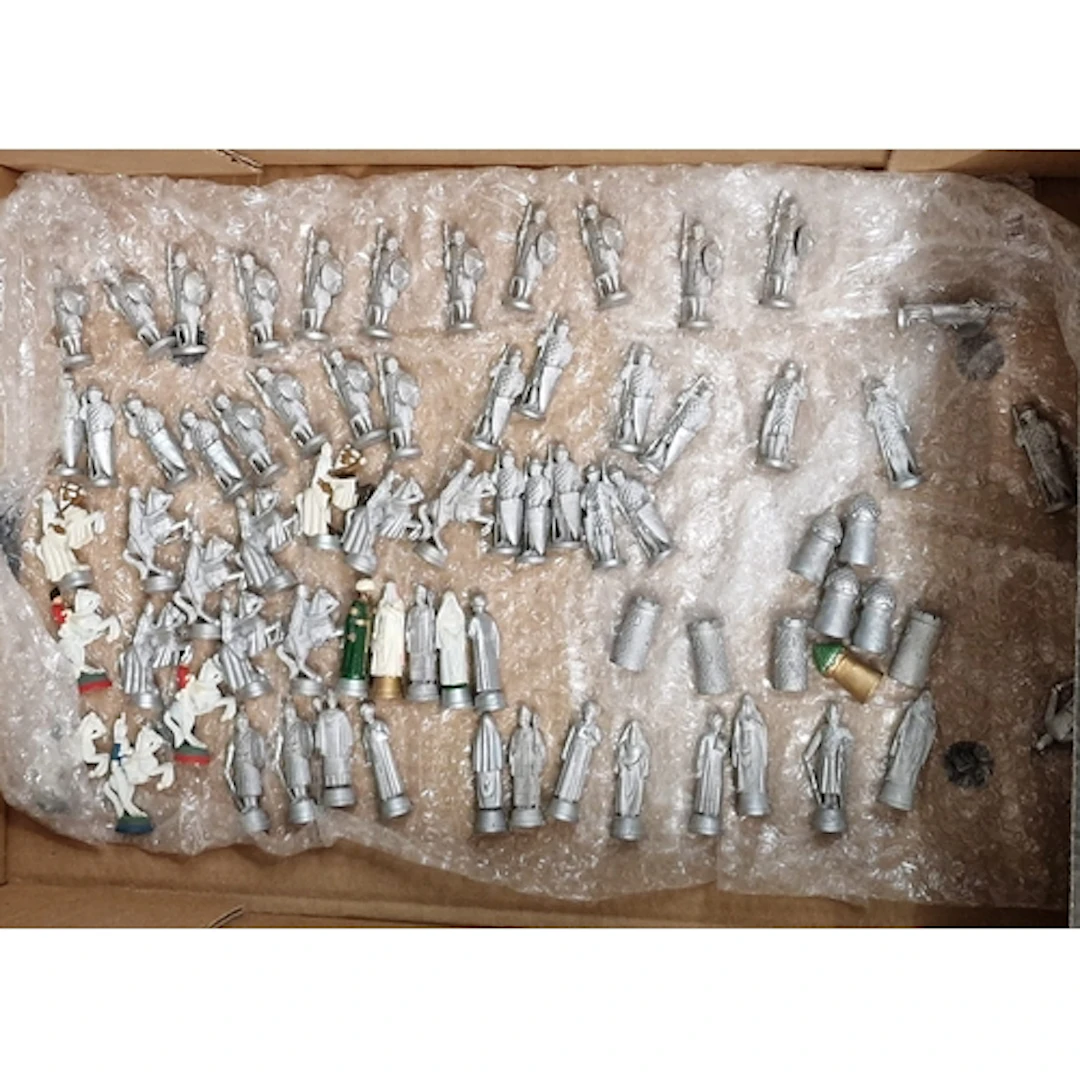 Box of white metal Chess pieces, predominantly depicting Cru...