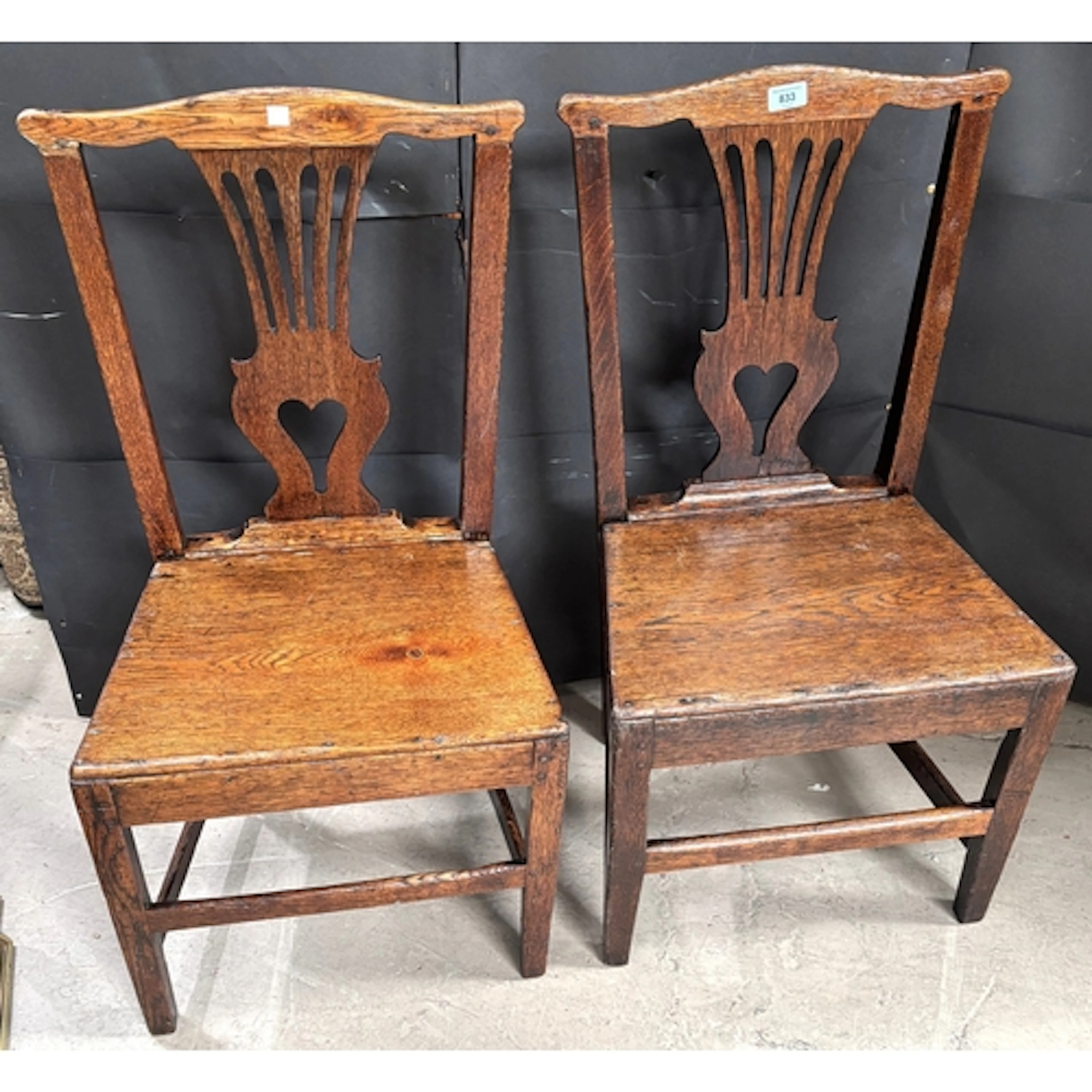 A pair of country oak Chippendale style George III chairs wi...