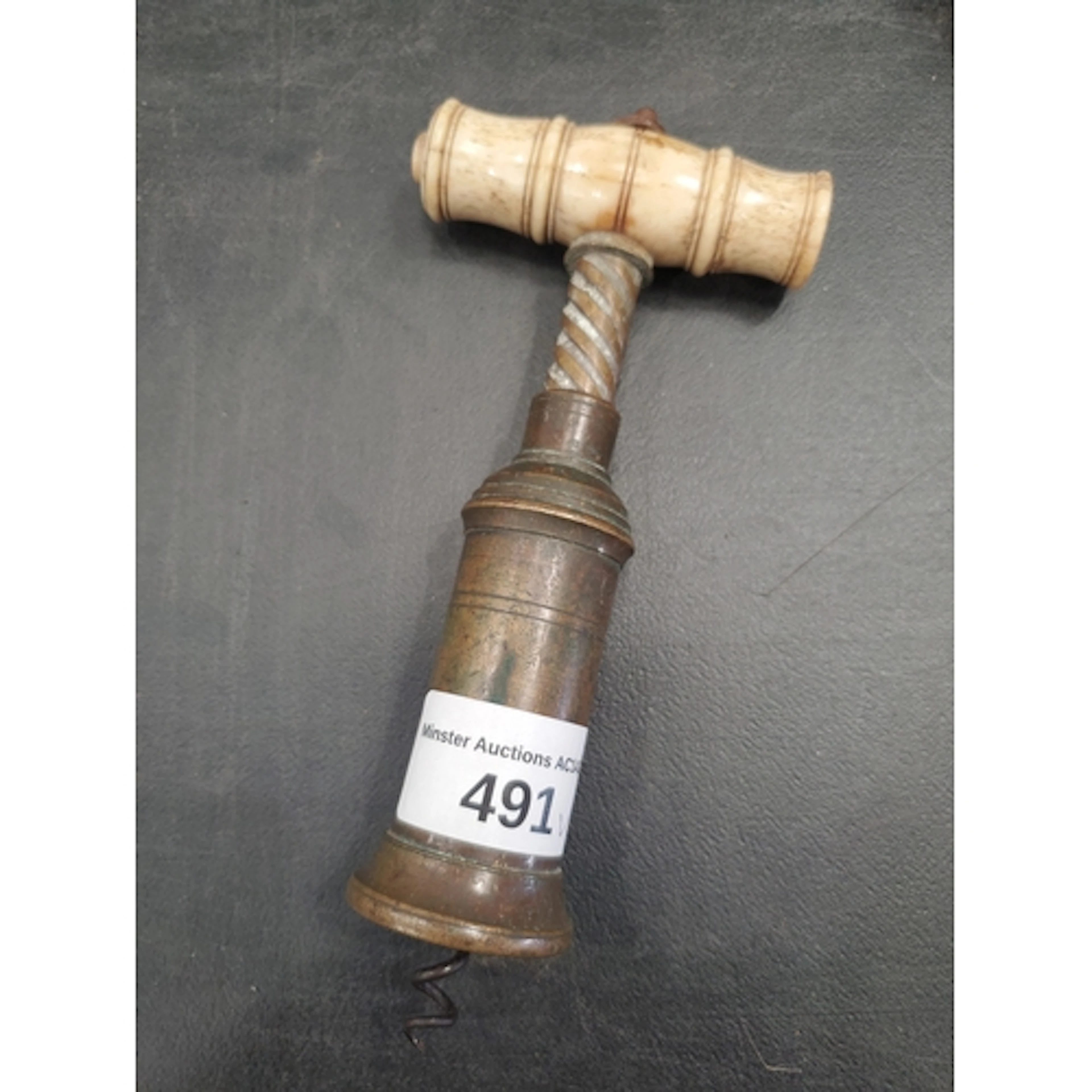 An antique bone handled Corkscrew with embossed crest (R5)