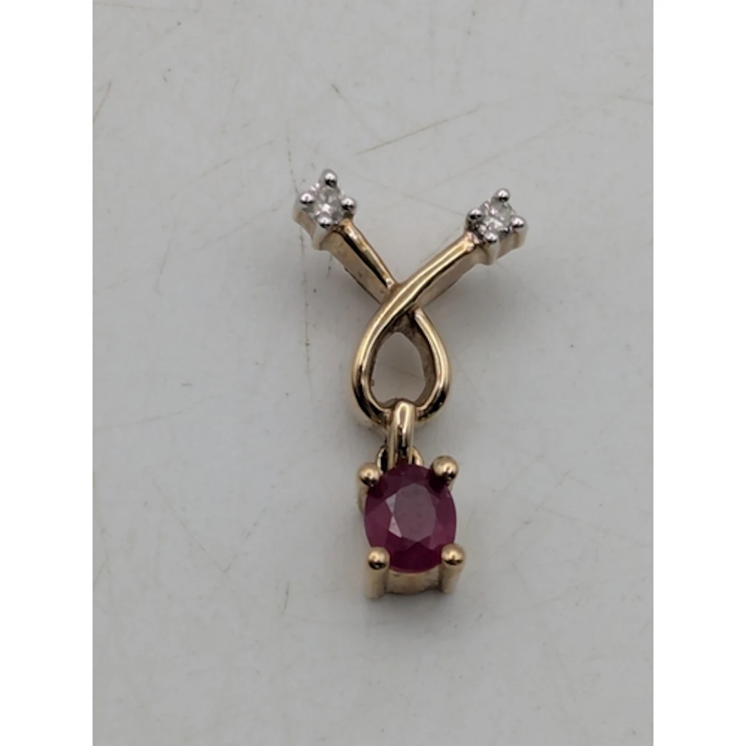 A ruby and diamond 9ct yellow gold cross over pendant, featu...