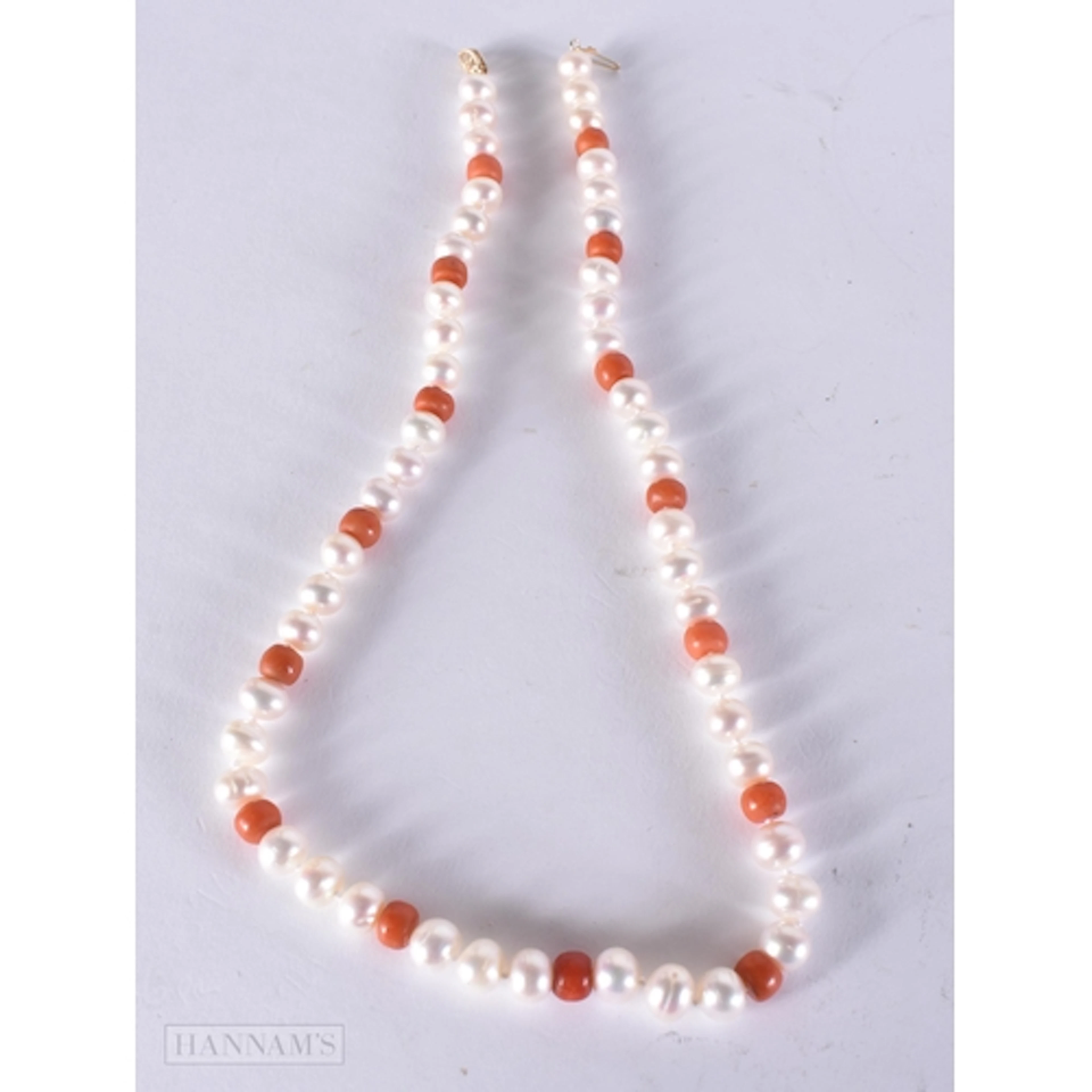 A 14CT PEARL AND CORAL STRING BEAD NECKLACE. 45 cm. 39.3 gra...