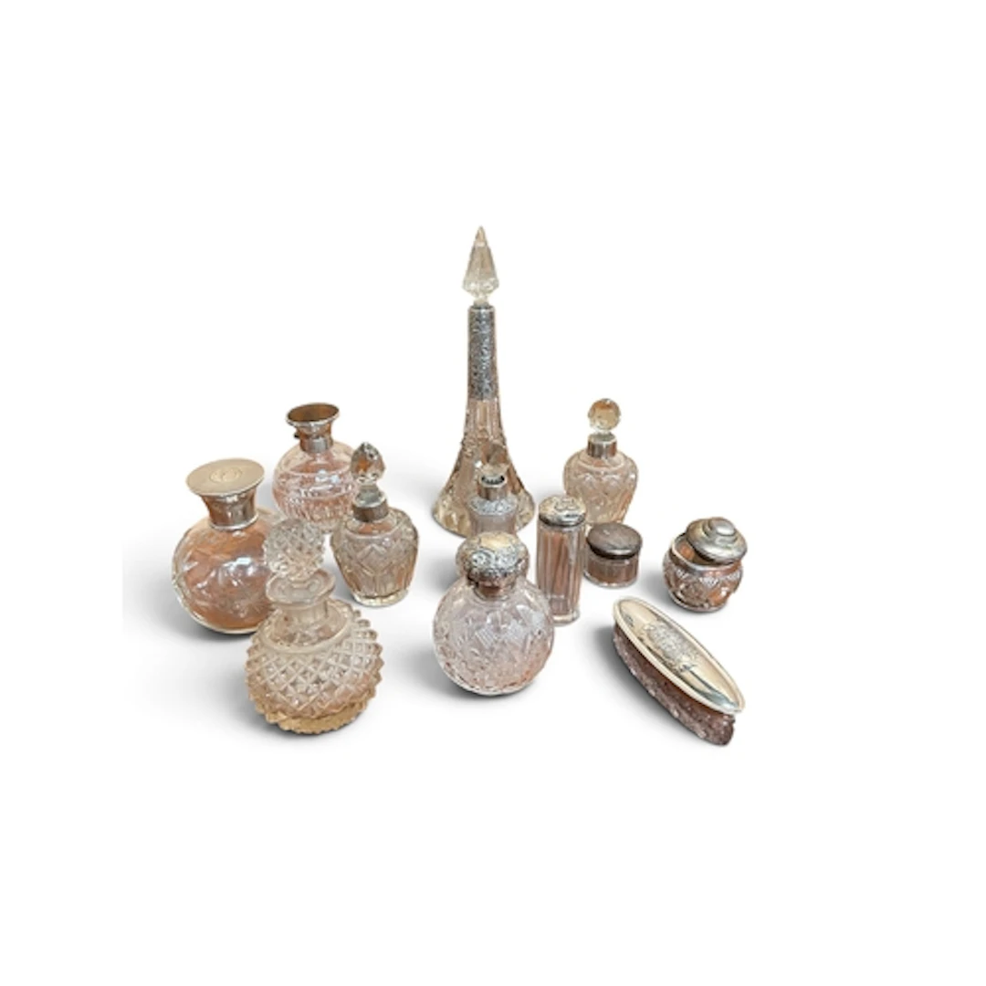 A QUANTITY OF GLASS AND SILVER TOPPED VANITY BOTTLES (11 in ...