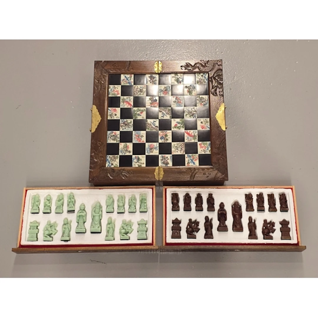 A vintage Chinese carved wood and tile chess set featuring a...