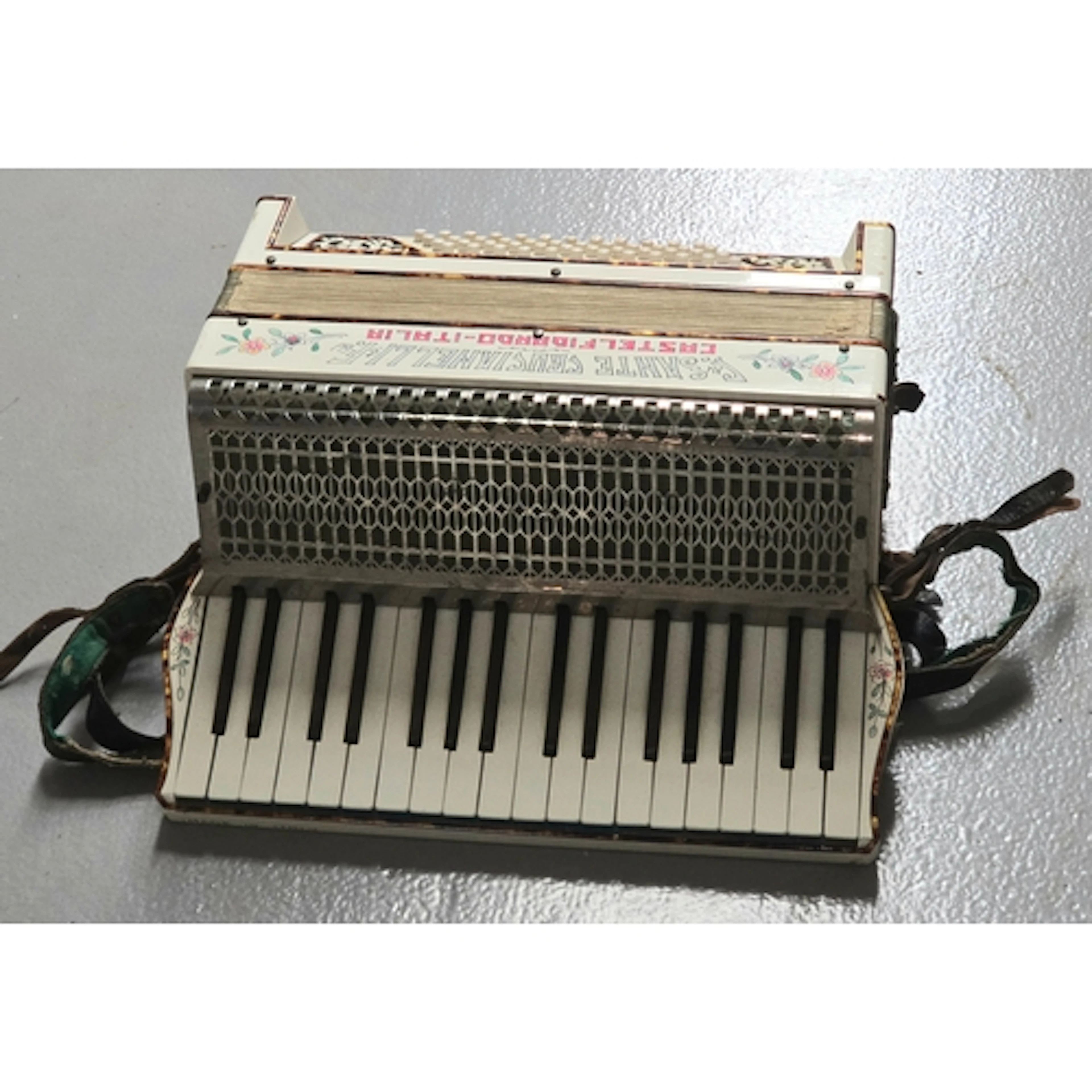 A vintage Italian piano accordion featuring elaborate inlaid...