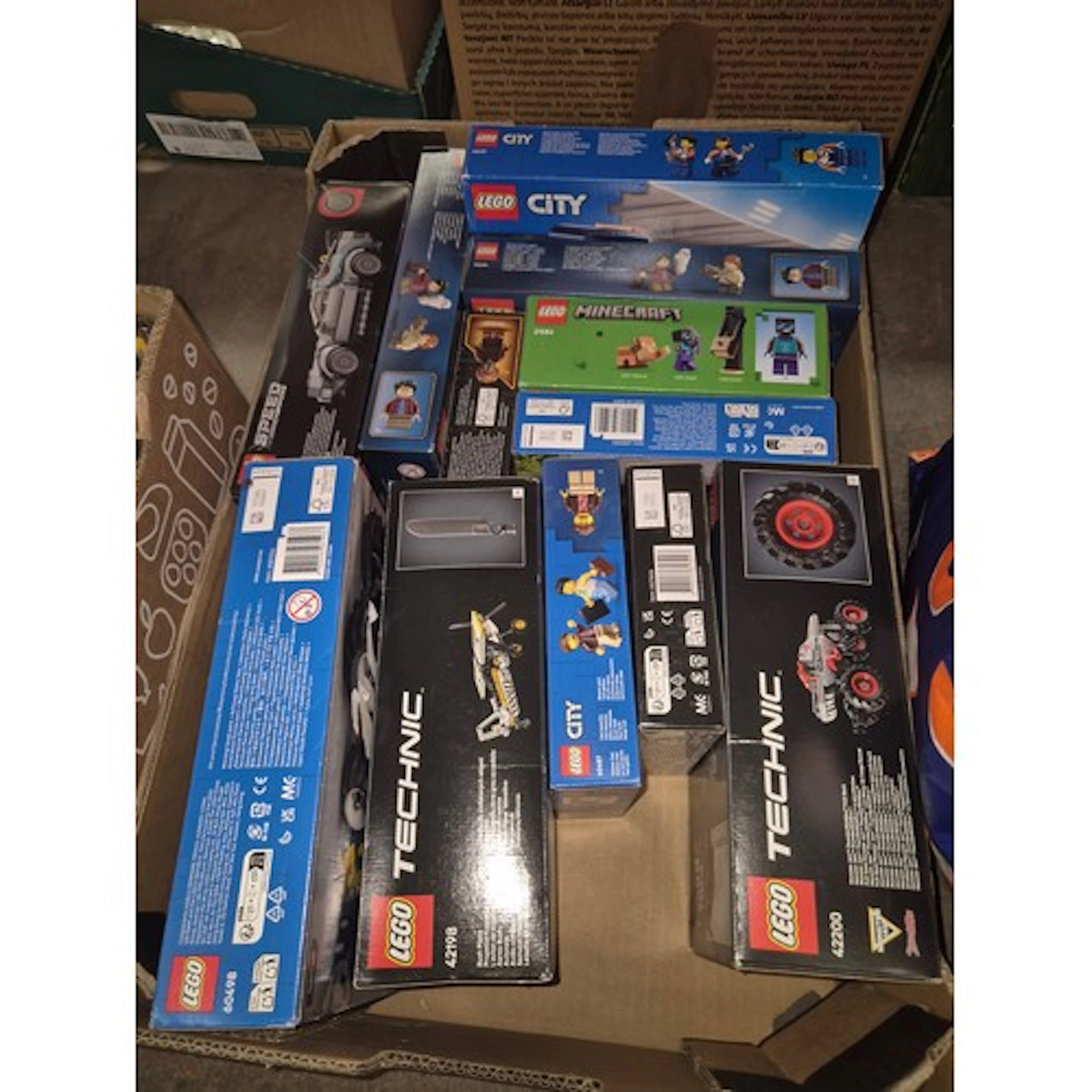 A box of assorted unopened Lego sets to include Technic, Sta...