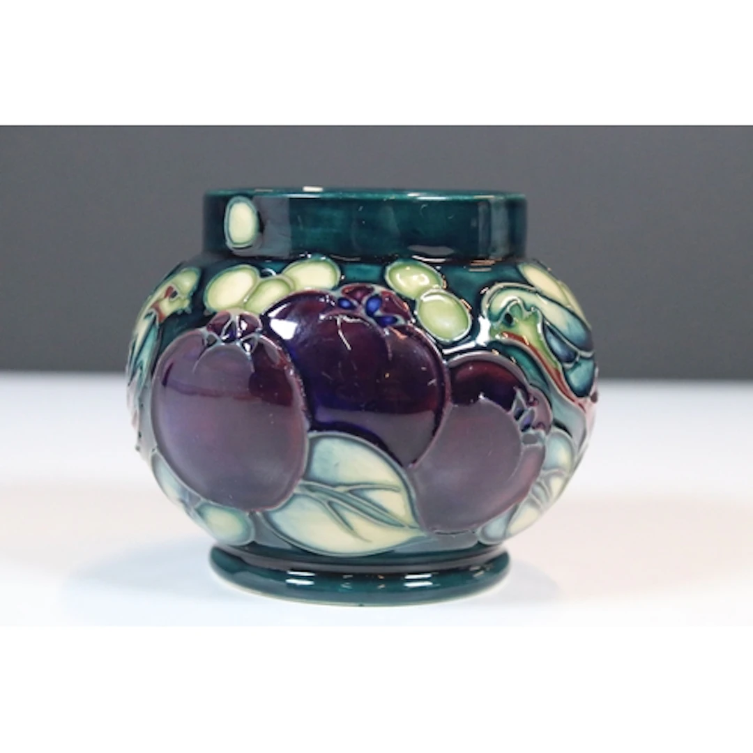 Moorcroft 'Finches' pattern vase on teal ground, designed by...