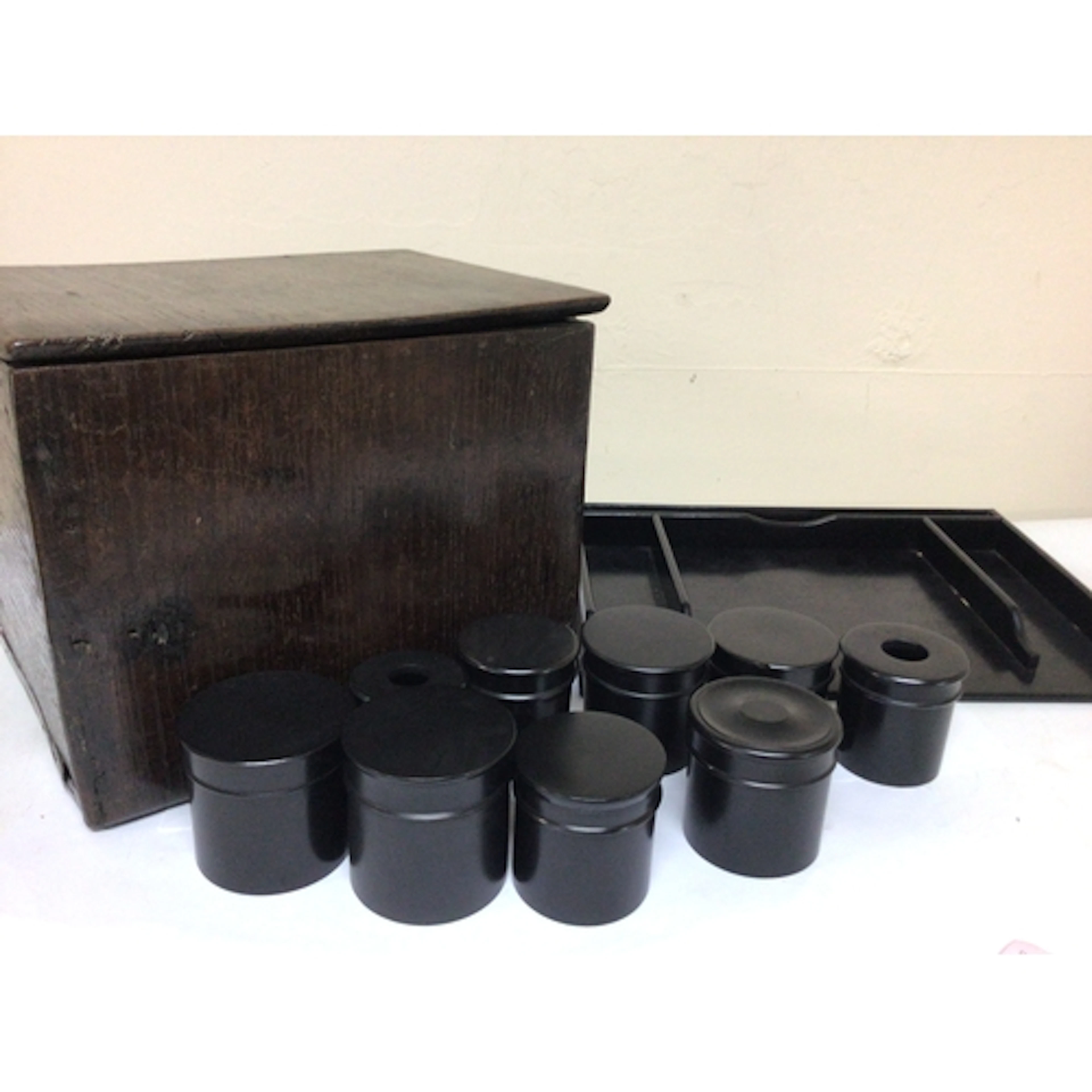 A collection of ebony wood pots with lids a tray and an oak ...