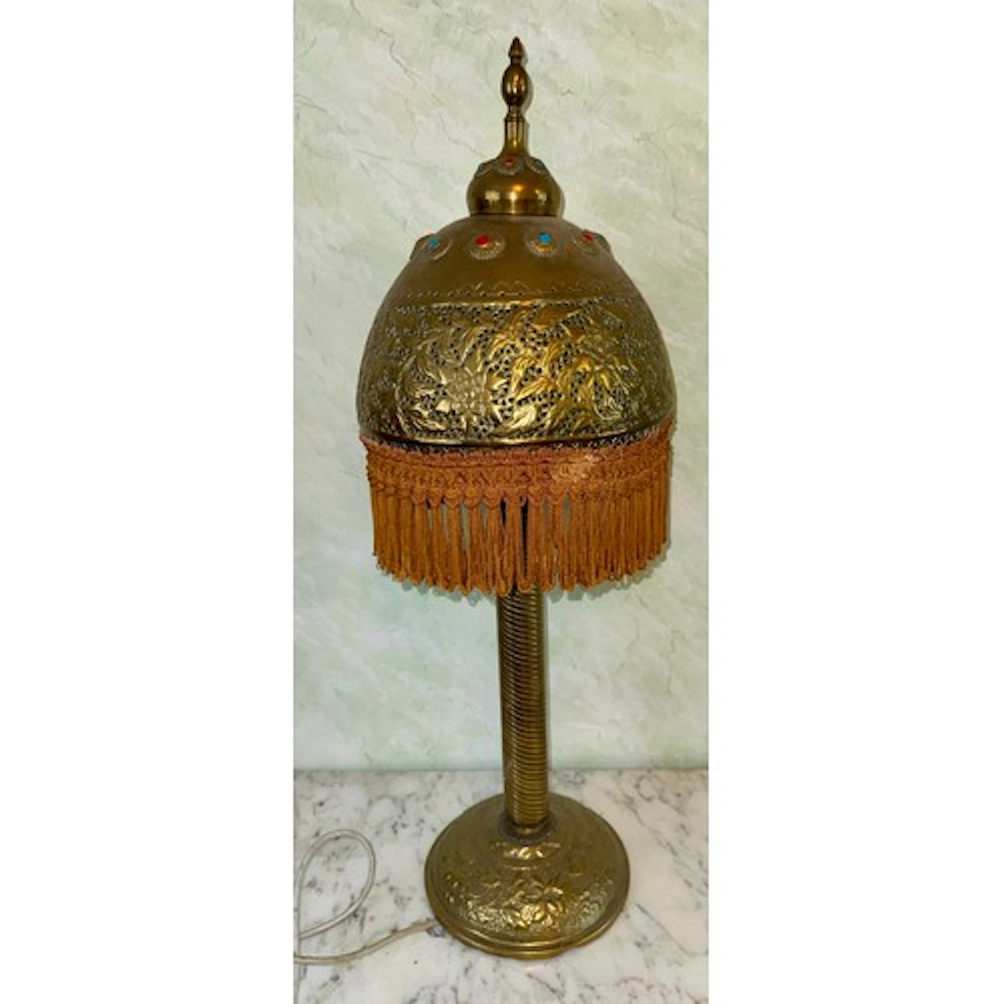 A Middle Eastern brass table lamp with twisted column and br...