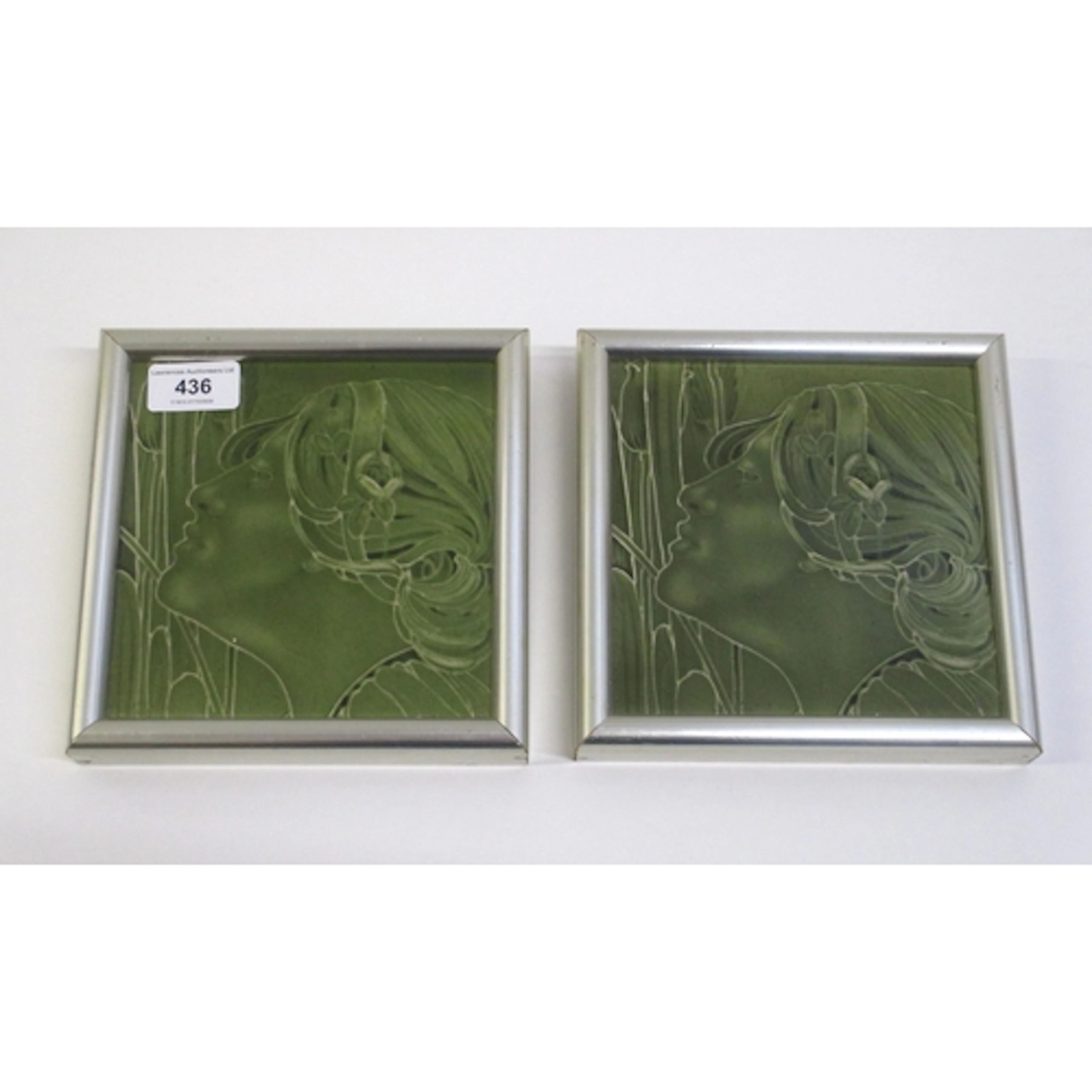 Pair of framed Art Nouveau green glazed tiles, profile of a ...