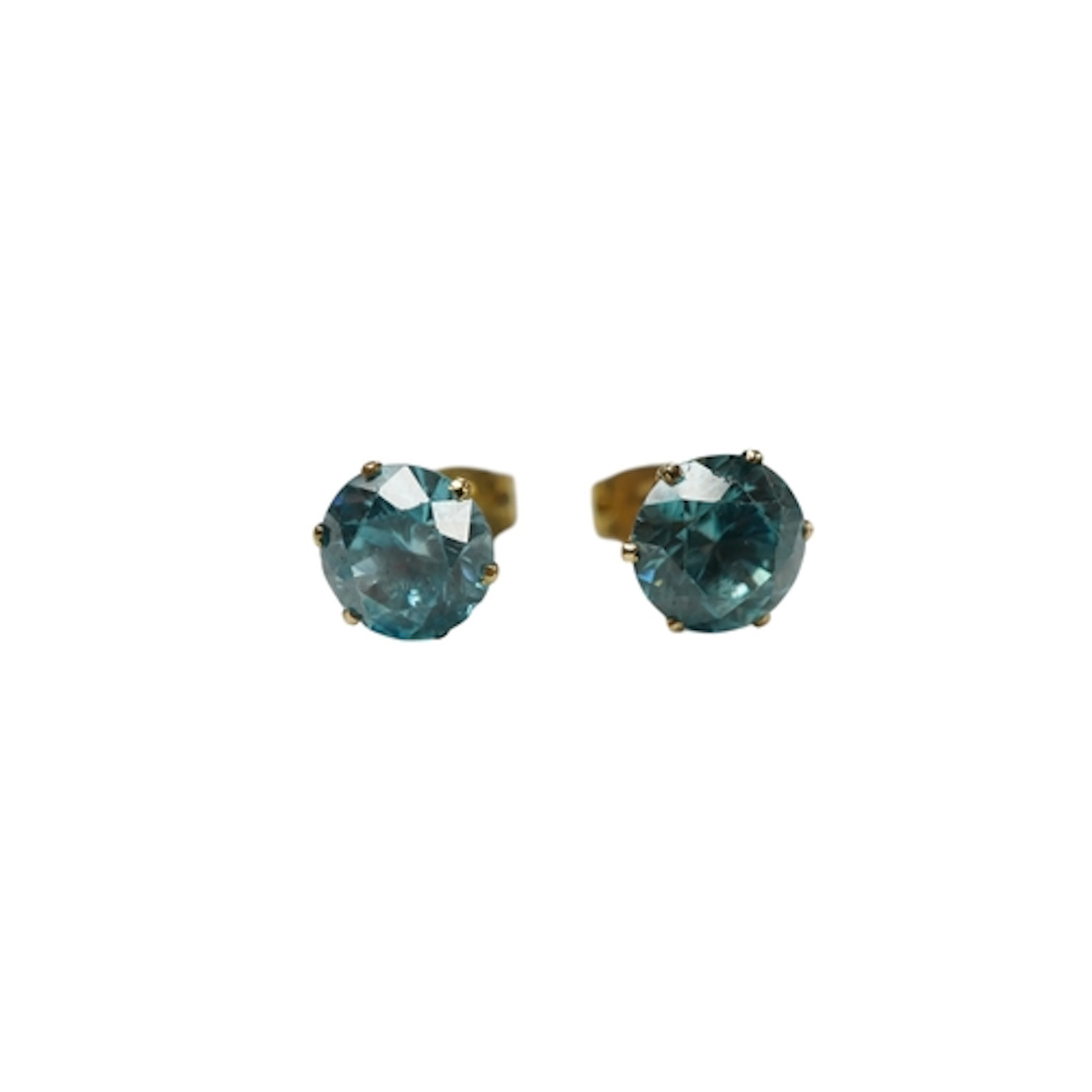 A pair of unmarked yellow metal and blue zircon set ear stud...