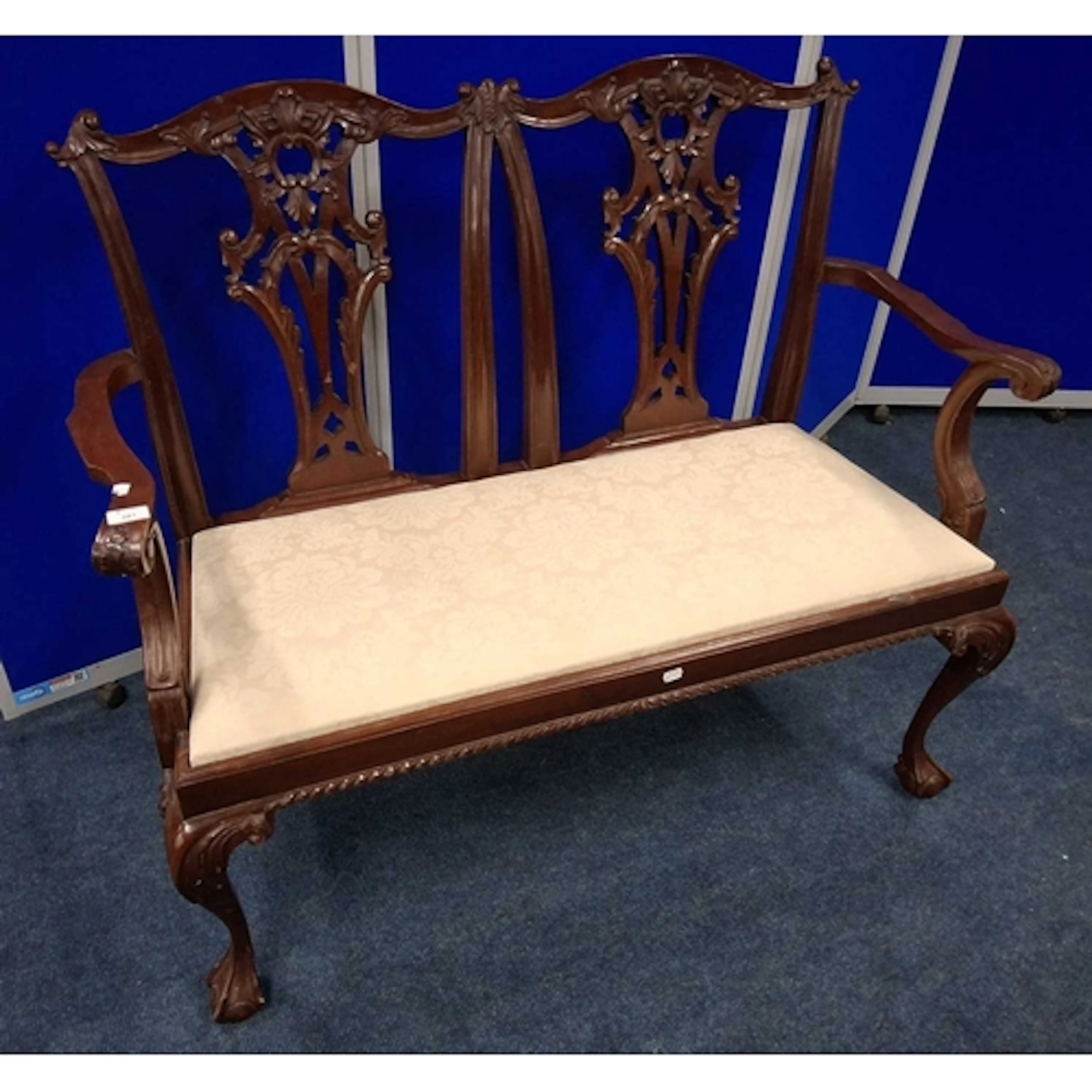 A REPRODUCTION CHIPPENDALE STYLE TWO SEATER SOFA, with scrol...