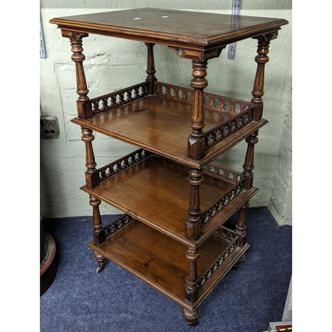 A Victorian mahogany four tier whatnot having reeded columns...
