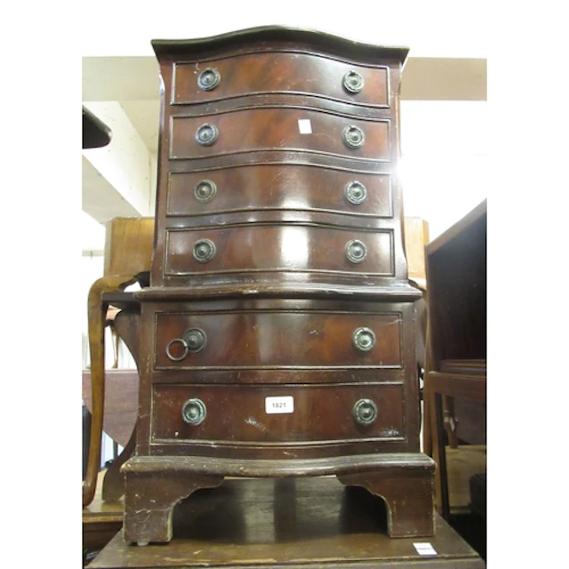 Reproduction mahogany serpentine fronted bedside chest, of s...