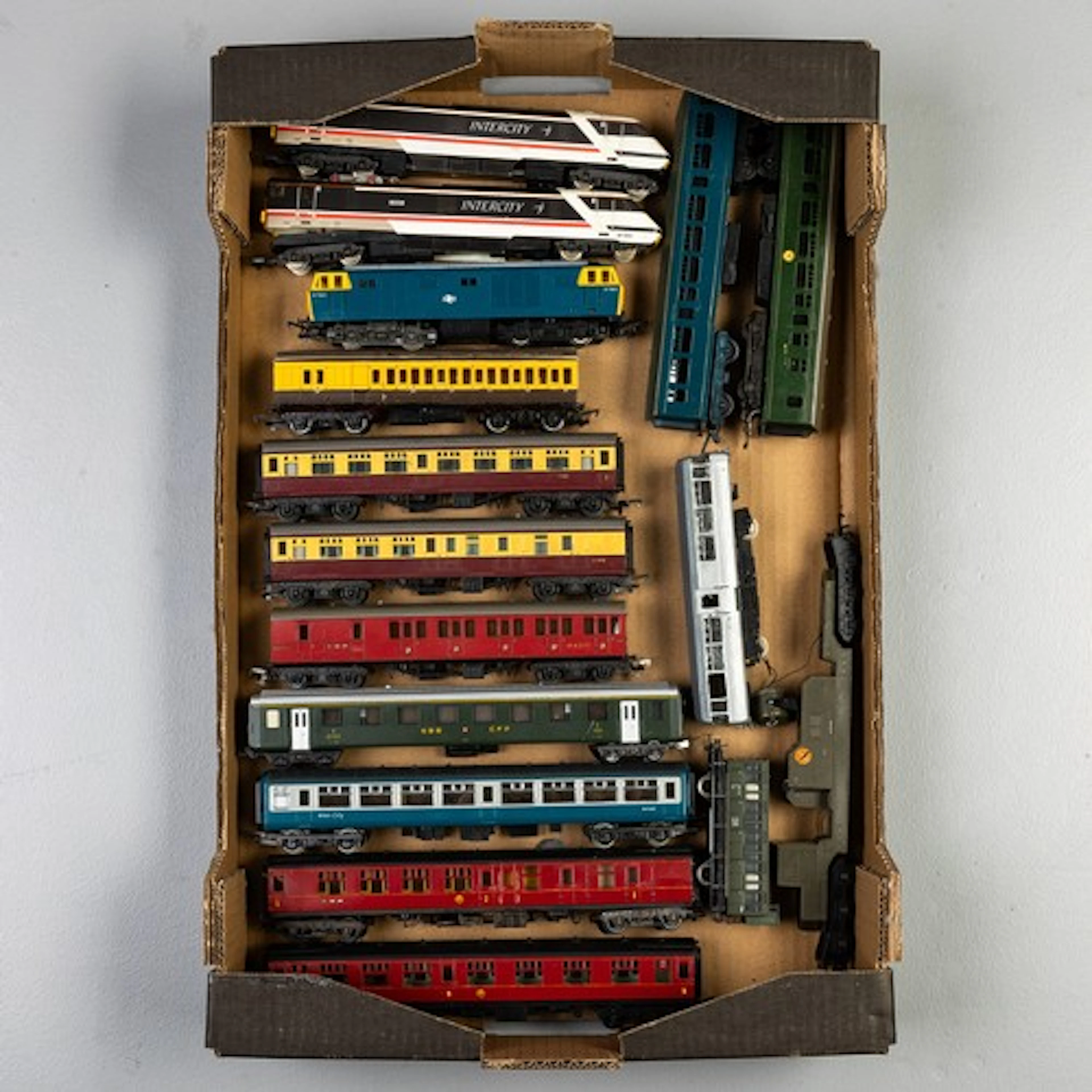 Three fruit trays, one containing 00 gauge diesels and coach...
