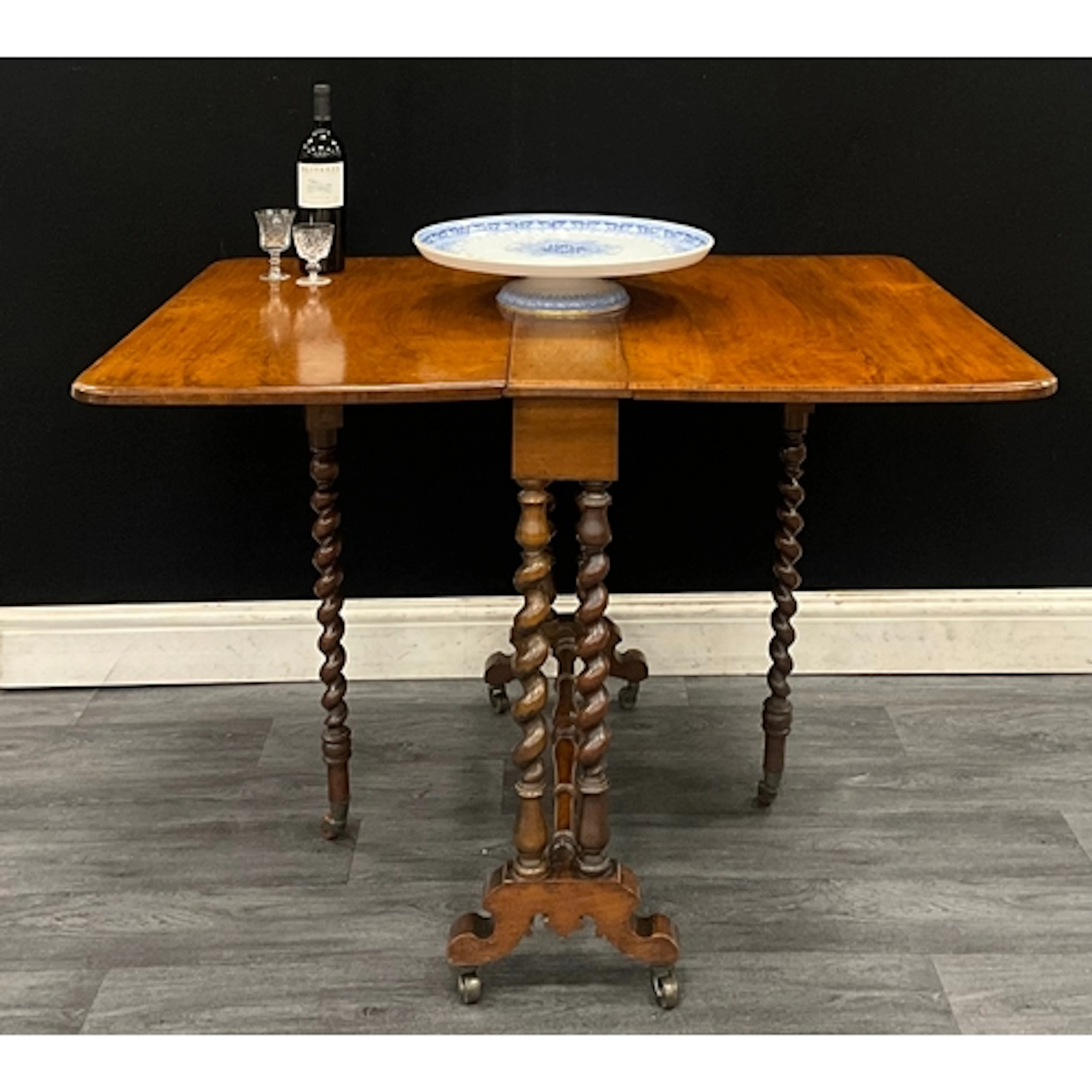 A Victorian walnut Sutherland table, rectangular top with ro...