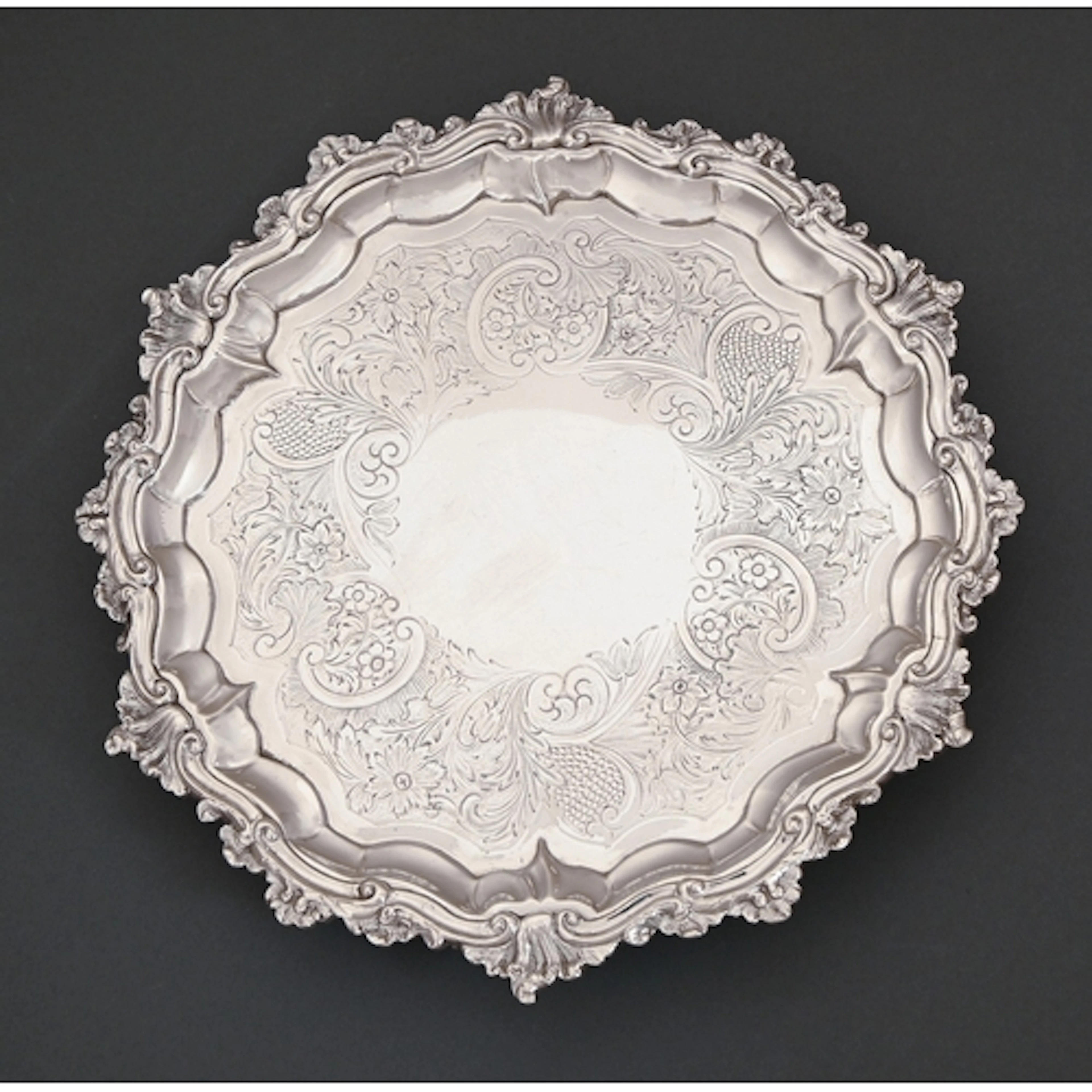 A William IV silver salver, flat chased with C-scrolls and f...