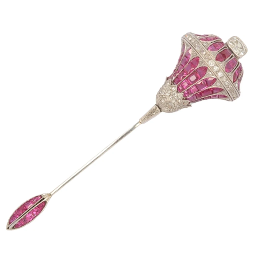 A ruby, synthetic ruby and diamond jabot pin, designed as a ...