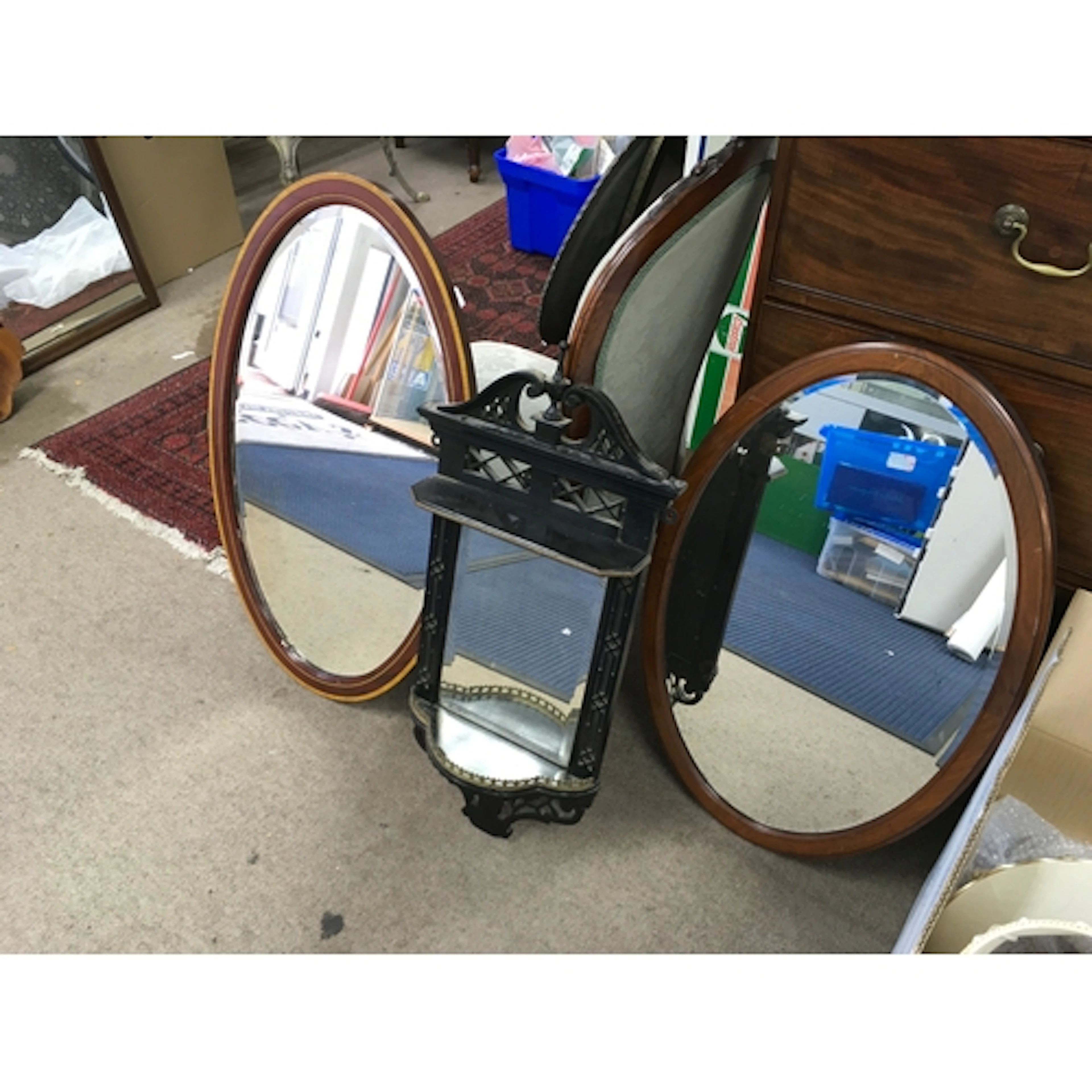 wooden wall-mounted mirror sconce and two mirrors.