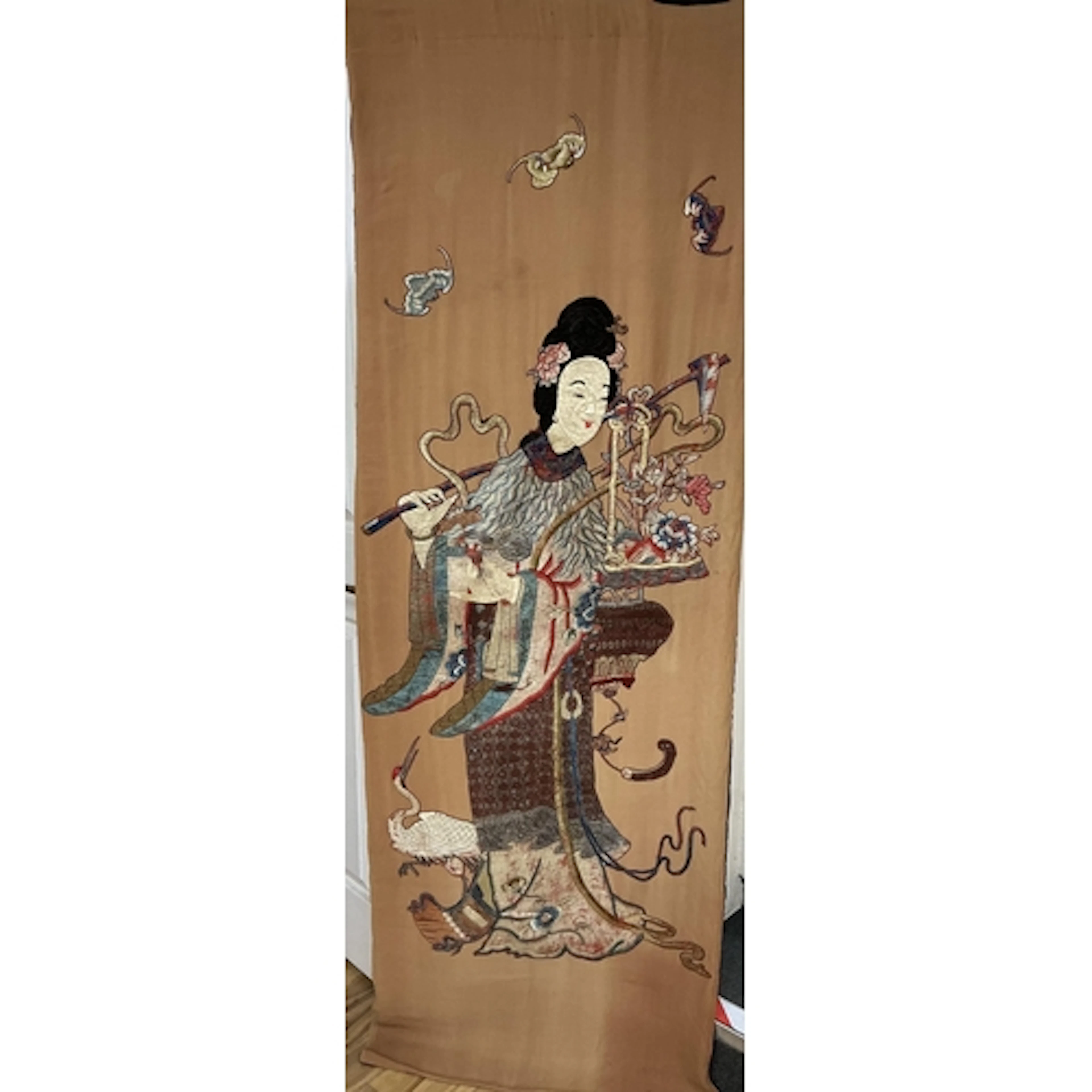 A Chinese embroidered silk hanging panel of He Xiangu, late ...
