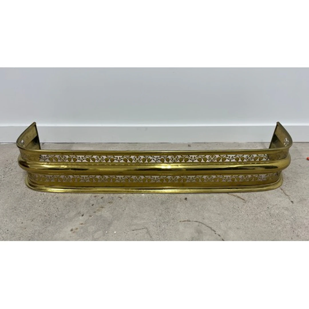 Brass pierced fire fender, 106 cm wide.