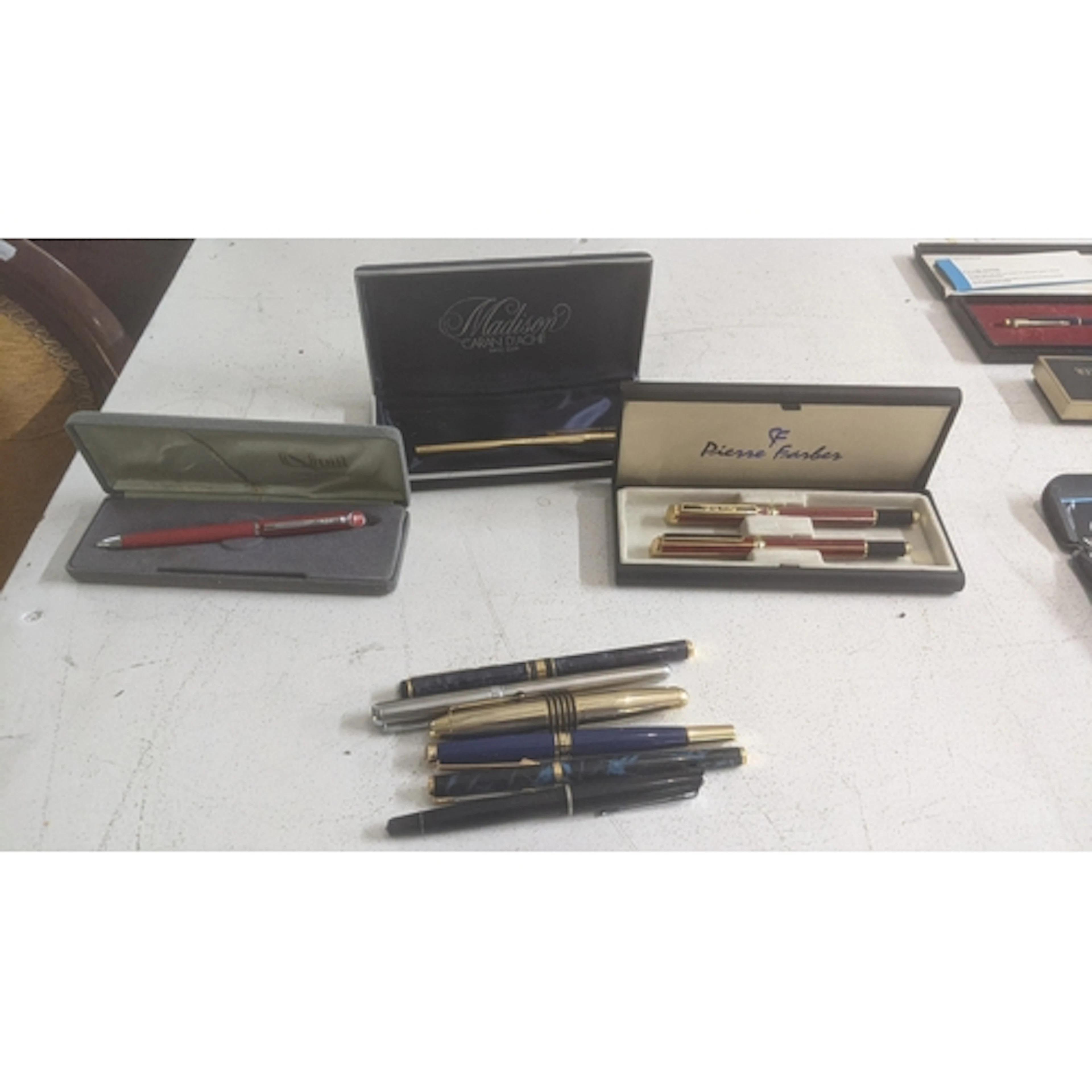 A collection of writing equipment to include a boxed Caran D...