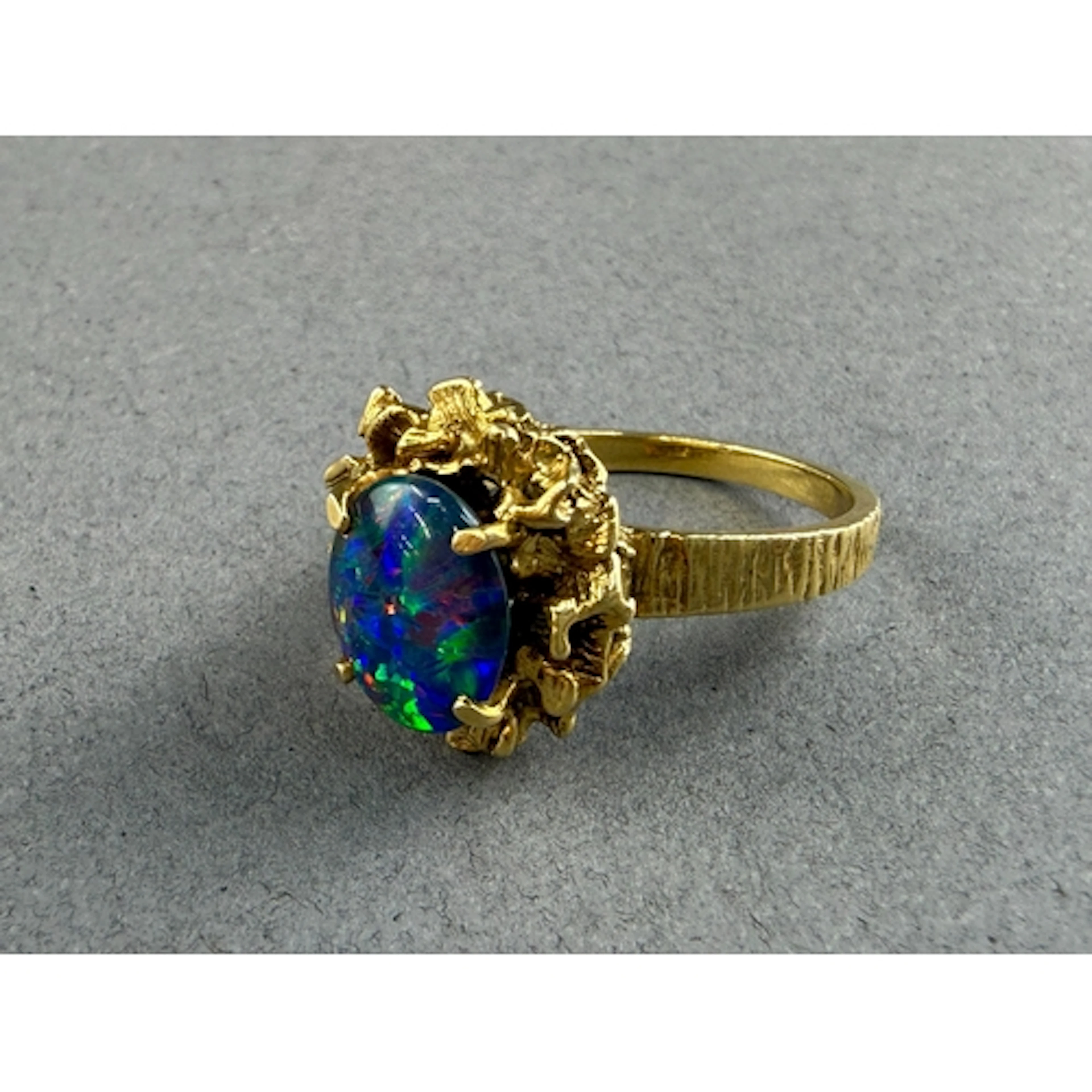 Jewellery: an Australian yellow metal and doublet black opal...