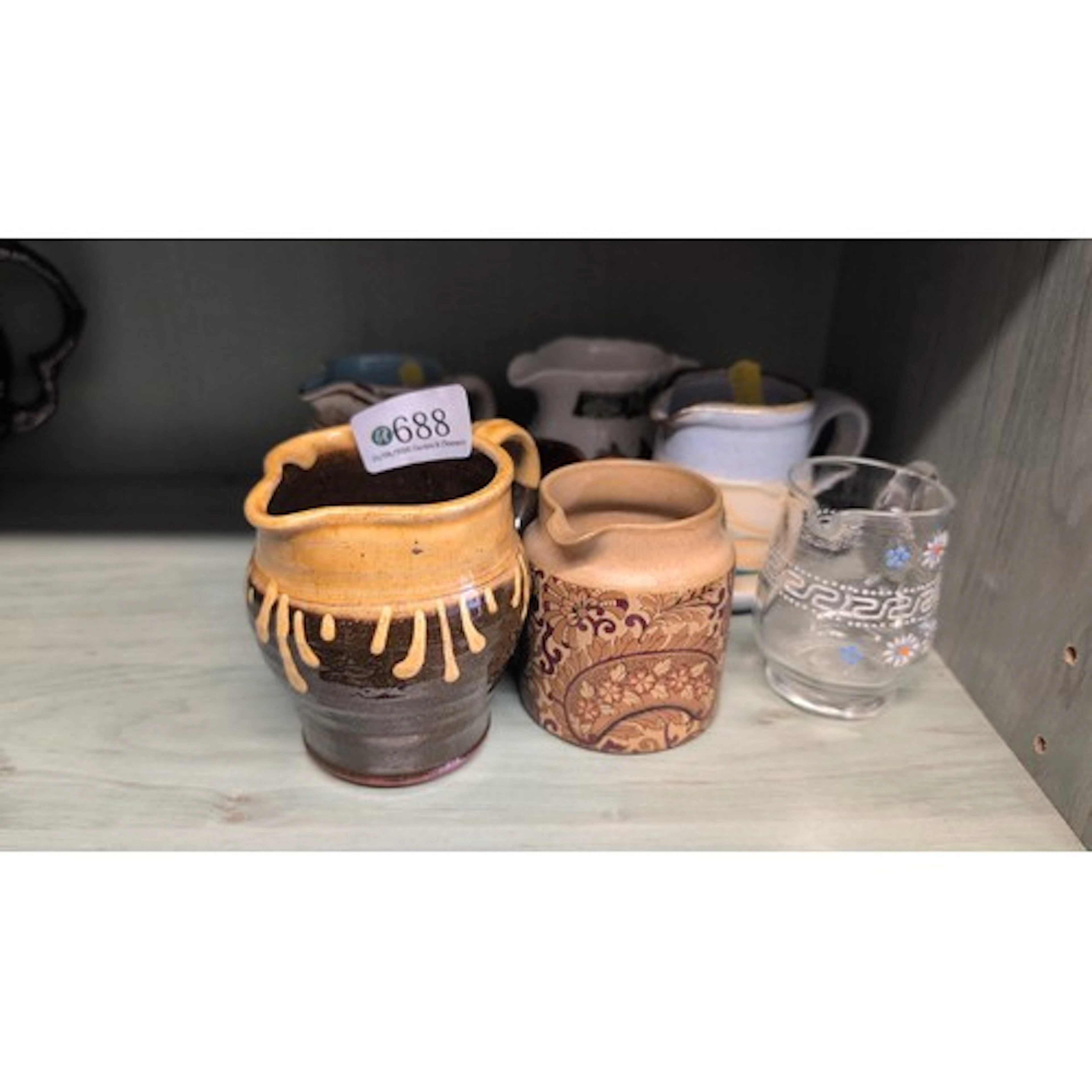 A group of ceramic and glass milk jugs, including a Royal Do...