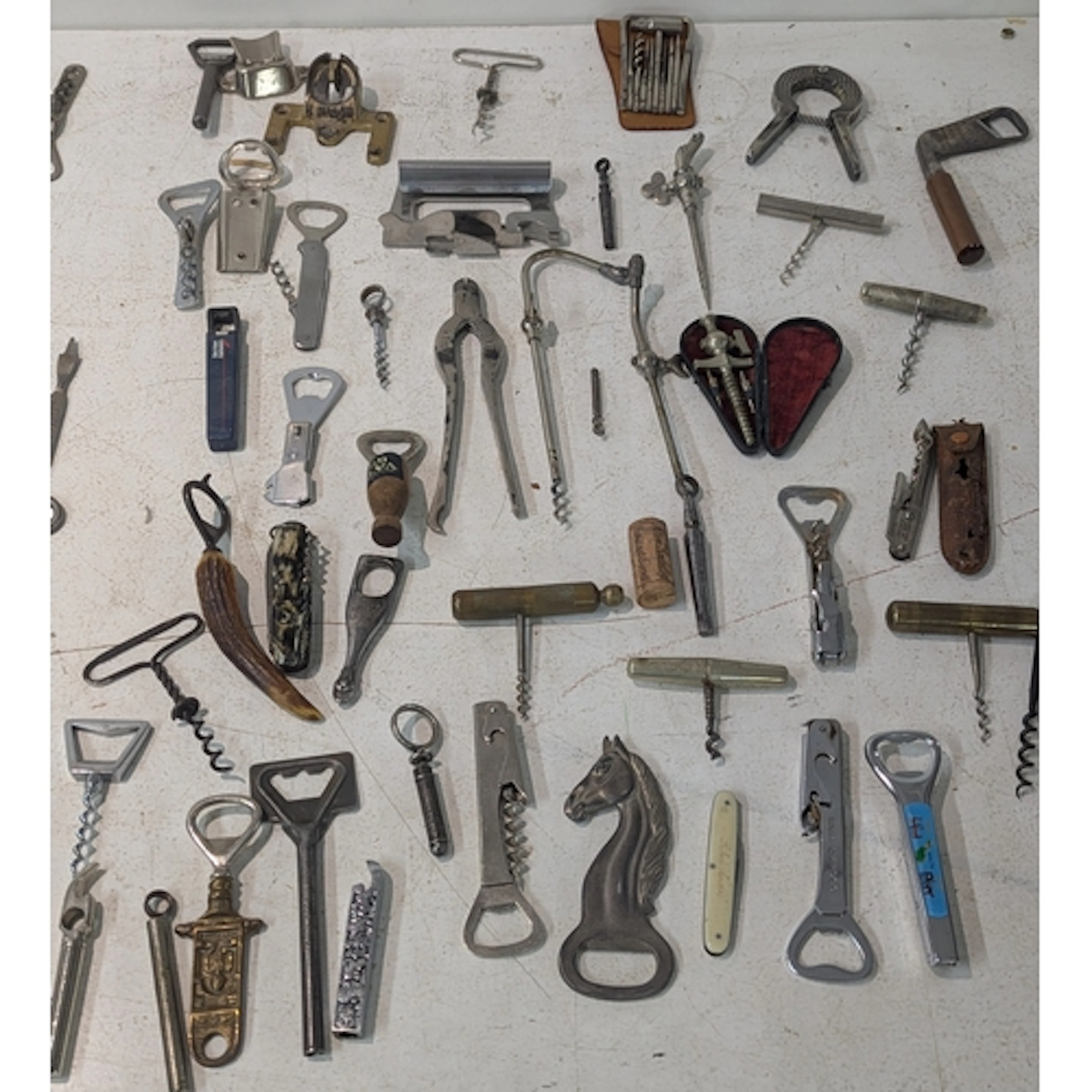 A collection of vintage corkscrews and bottle openers to inc...