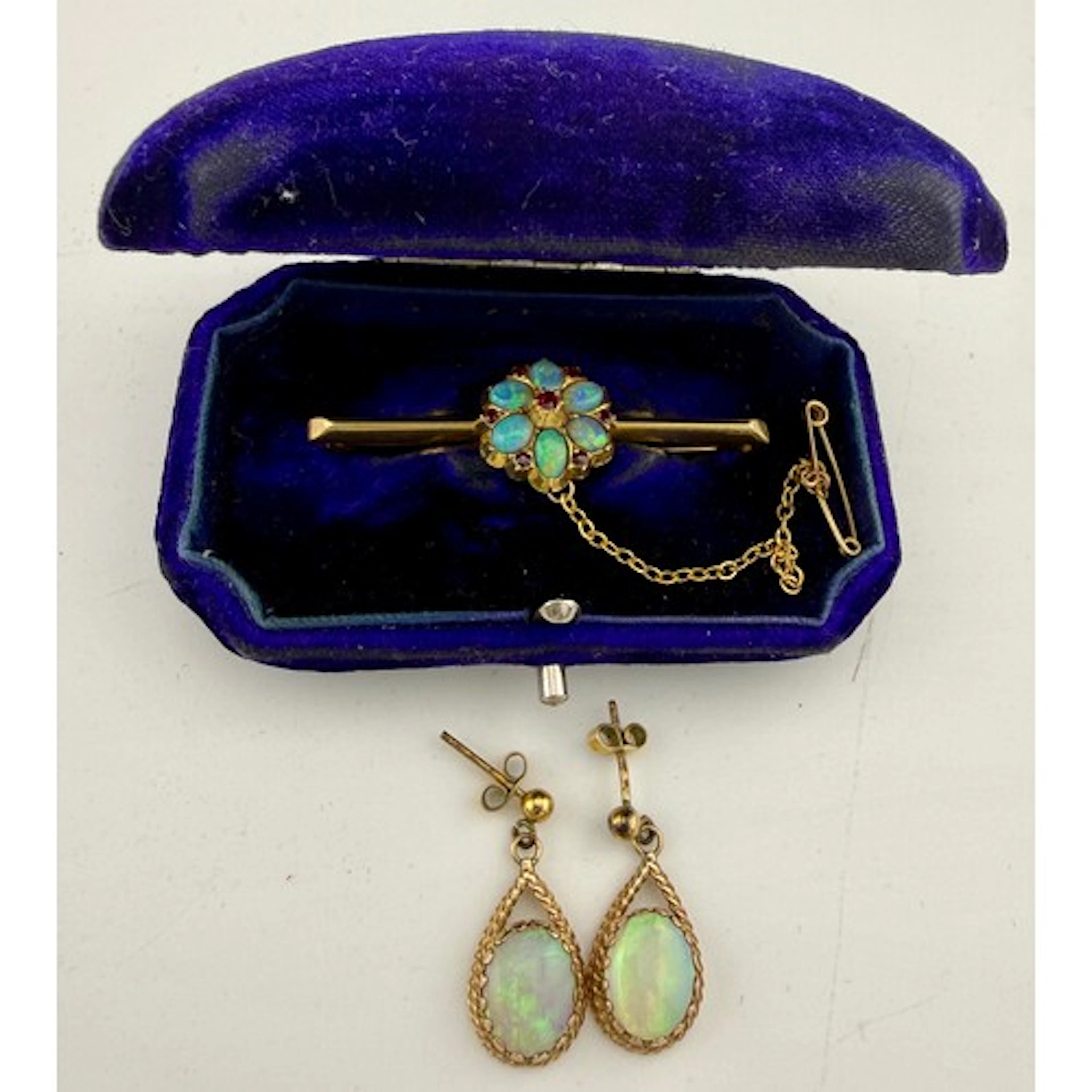 A 15 carat gold bar brooch in fitted case set with opals and...