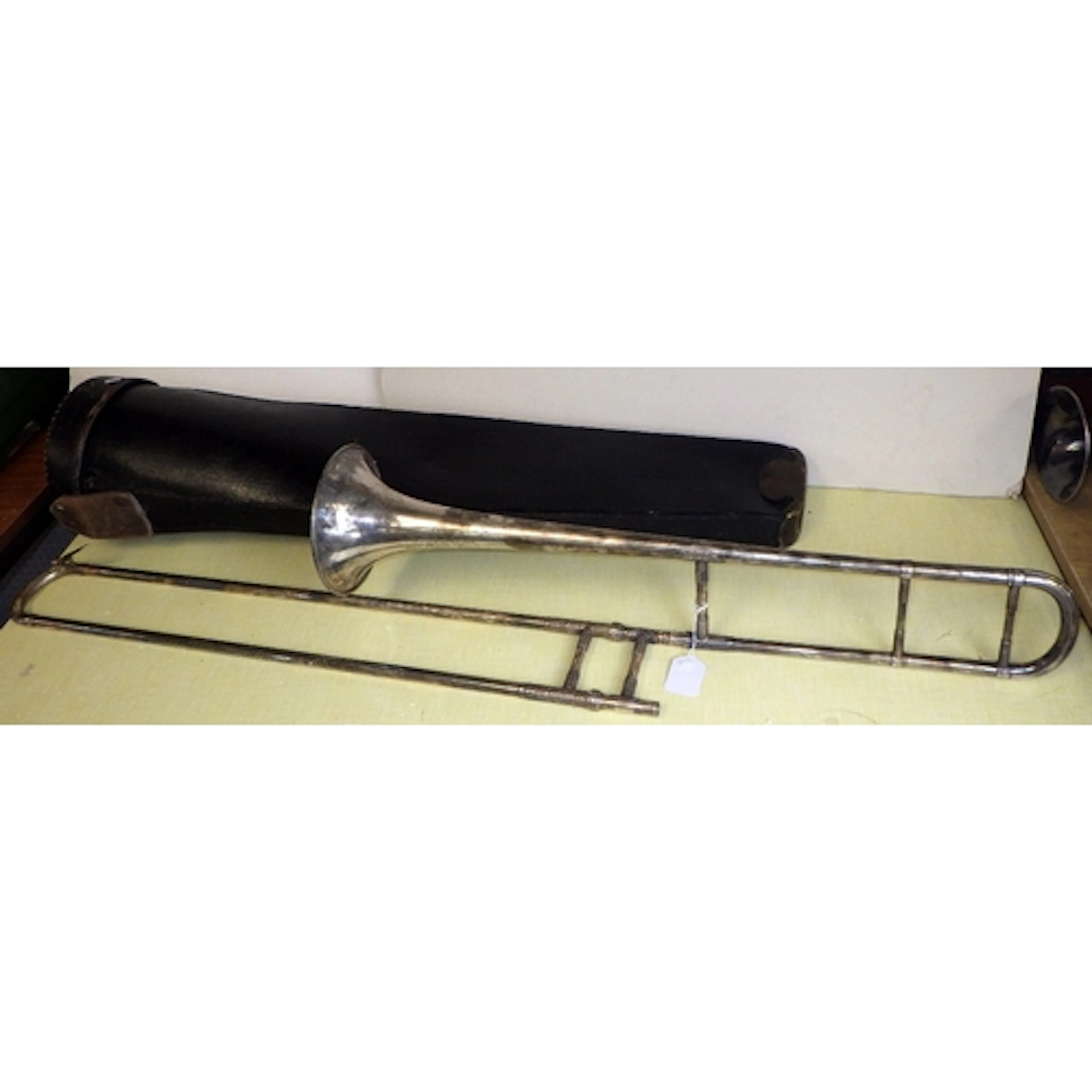 A cased Hawkes & Son silver plated trombone af