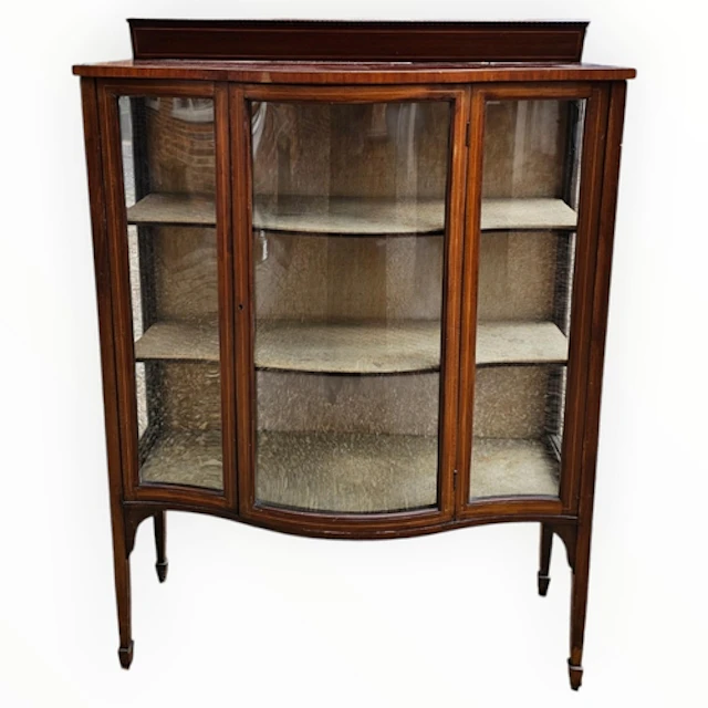 AN EDWARDIAN MAHOGANY AND SATINWOOD DISPLAY CABINET With bow...