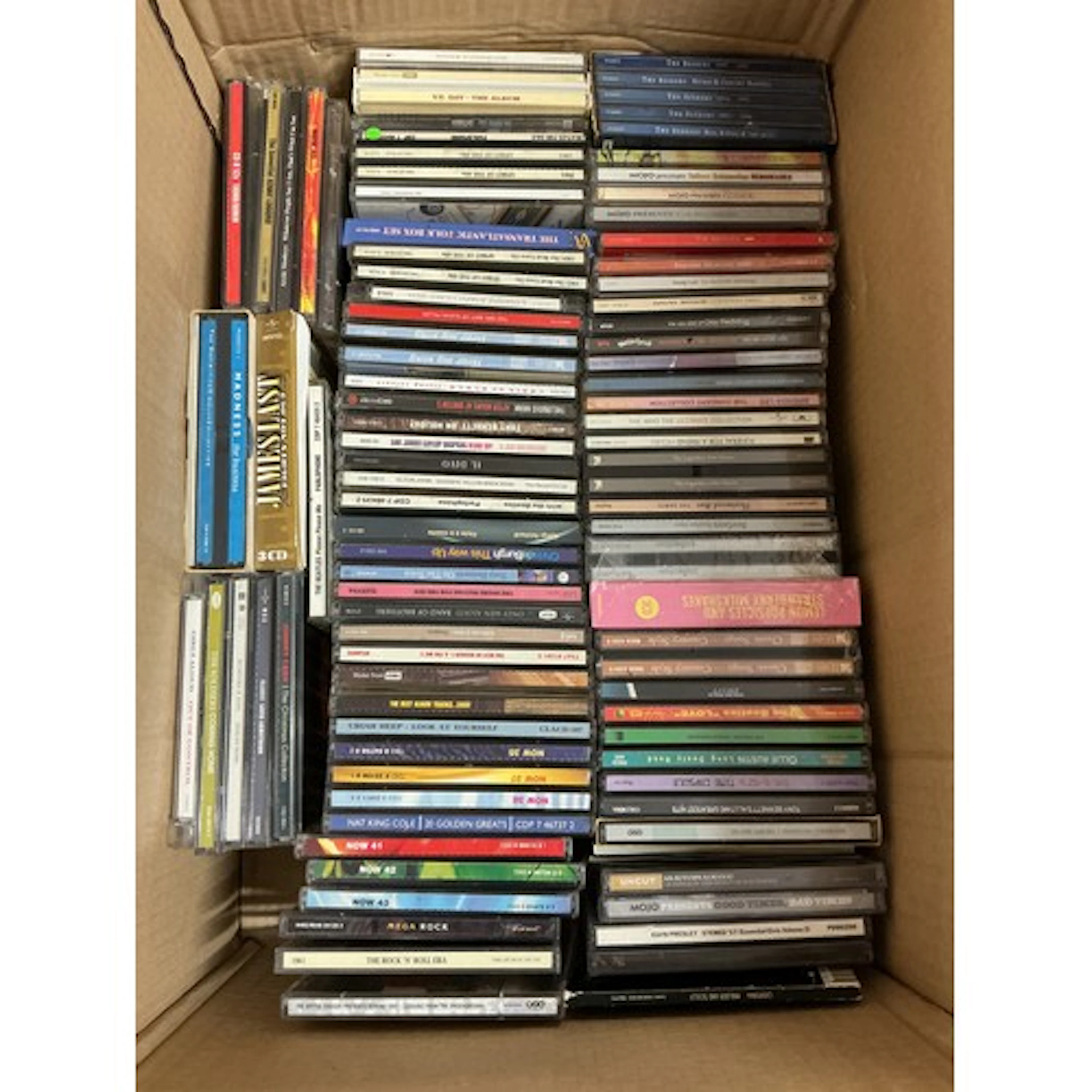 Four boxes of CDs by various artists including The Beatles, ...
