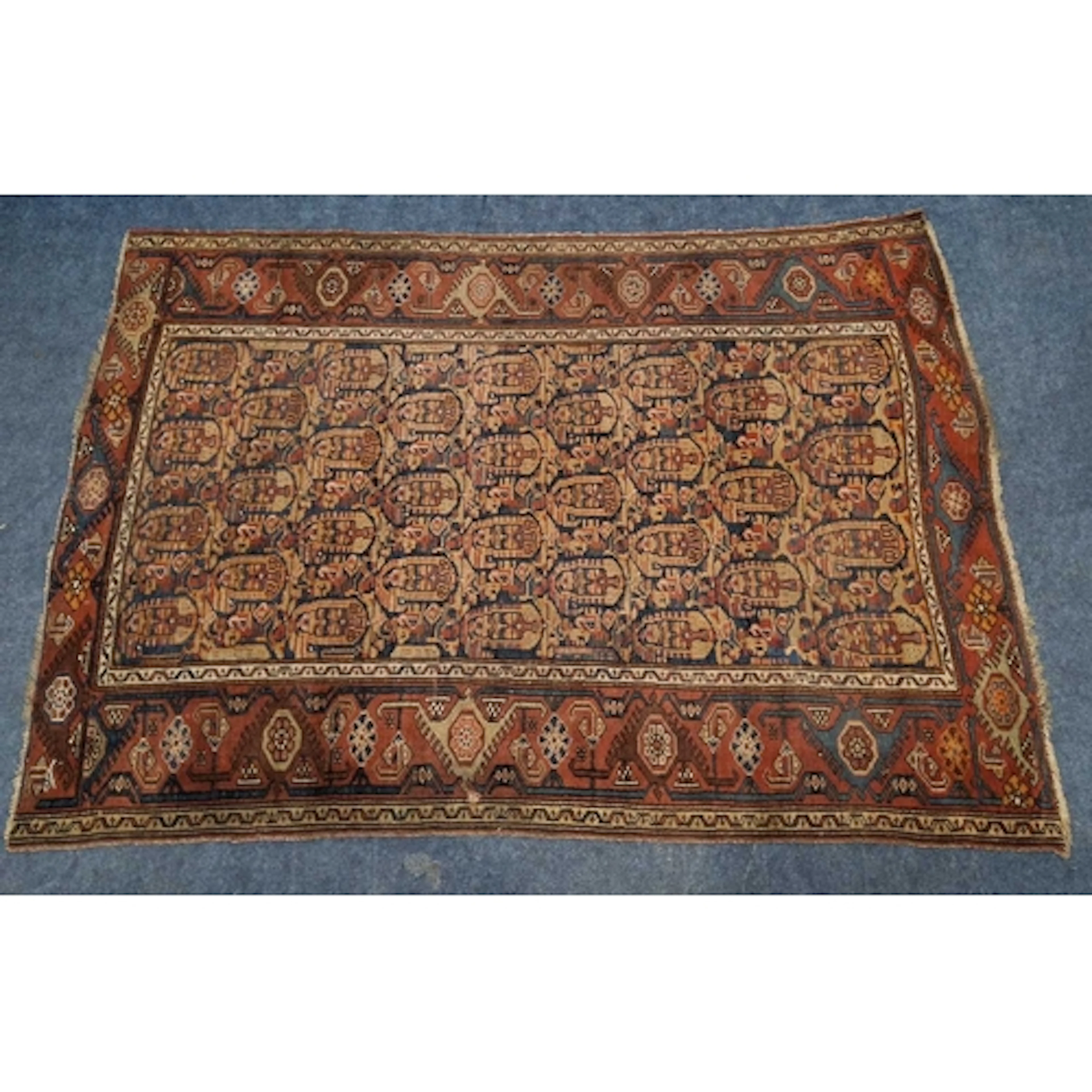 A RED AND BLUE GROUND HAND-KNOTTED RECTANGULAR RUG, with rep...